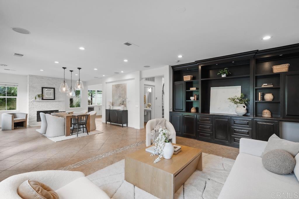 Perfectly positioned on a premium cul-de-sac lot in the coveted La Costa Greens community, this beautifully upgraded residence offers a flexible floor plan with 4 bedrooms, 4.5 bathrooms, a dedicated office space, and versatile loft. Designer details shine throughout, from freshly painted crisp white walls and crown molding to statement light fixtures and a dramatic spiral staircase. The formal dining room right off of the kitchen provides a cozy space perfect for intimate gatherings, while the private office features glass doors, custom built-ins, and an executive desk. The expansive great room blends comfort and style with multiple seating areas, a built-in entertainment center, and a fireplace wrapped in floor-to-ceiling stacked stone, all overlooking the lush backyard. The chef’s kitchen showcases white cabinetry, quartz countertops, and a designer tile backsplash, all centered around a spacious island, and is enhanced by double ovens, a wine refrigerator, a deep apron sink, and a dedicated coffee station. Upstairs, offers an open loft with built-in desks perfect for family overflow and entertainment as well as three secondary bedrooms, all with en-suite bathrooms, an ideal setup! The spacious primary suite offers a private balcony, oversized shower with dual showerheads, deep soaking tub, dual vanities, linen closet, and a large walk-in closet with built-ins. The private backyard is a serene oasis surrounded by lush landscaping, featuring a built-in firepit, elevated dining patio, grassy play area, and two generous side yards - one adorned with a pergola gracefully draped in greenery. Additional highlights include fully owned solar, a 2-car garage right off of the dedicated laundry room with storage cabinets as well as a separate single car garage with epoxy flooring and upper storage racks. Enjoy access to The Presidio, featuring a clubhouse, junior Olympic-size pool, spa, fitness center, and a scenic lake with walking path - plus nearby tennis and pickleball courts, playground, and open green space. La Costa Greens offers a premier neighborhood conveniently located near top tier schools: La Costa Meadows Elementary, San Elijo Middle School, & San Marcos High School. Enjoy nearby daily conveniences in the Bressi Ranch shopping center, easy access to the beach, freeways and more! Buyer and buyer’s agent to verify all in MLS prior to COE