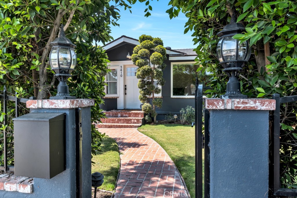 Welcome to this beautifully reimagined Atwater Village bungalow, where timeless character meets modern updates. Hidden behind a lush wall of greenery, the home immediately captivates with its arched entry, brick walkway, and meticulously designed landscaping. Inside, a light-filled living room showcases custom wall detailing with beadboard and wainscoting, while an adjoining sunroom or office delights with exposed brick and an oversized picture window. The seamless floor plan flows into a spacious dining room and a thoughtfully designed kitchen featuring custom cabinetry, stainless steel appliances, and generous counter space—perfect for everyday cooking and entertaining. Tucked away in the rear of the home, the private primary suite offers a spa-like bath, oversized closet, and new motorized window shades, while two additional bedrooms share a stylish jack-and-jill bathroom. The backyard is a true retreat with landscaped grounds ideal for play, relaxation, or outdoor dining, complemented by a custom cowboy soaking tub, all secured with brand-new yard gates and a rear wrought iron fence. The finished garage provides incredible flexibility—whether used as a creative studio, office, or game room. Just moments from the heart of Atwater Village, you’ll enjoy local cafés, shops, farmers markets, and quick access to the LA River Trail. With preserved original details blended seamlessly with chic modern upgrades, this home offers the perfect opportunity to embrace Atwater Village living at its finest.