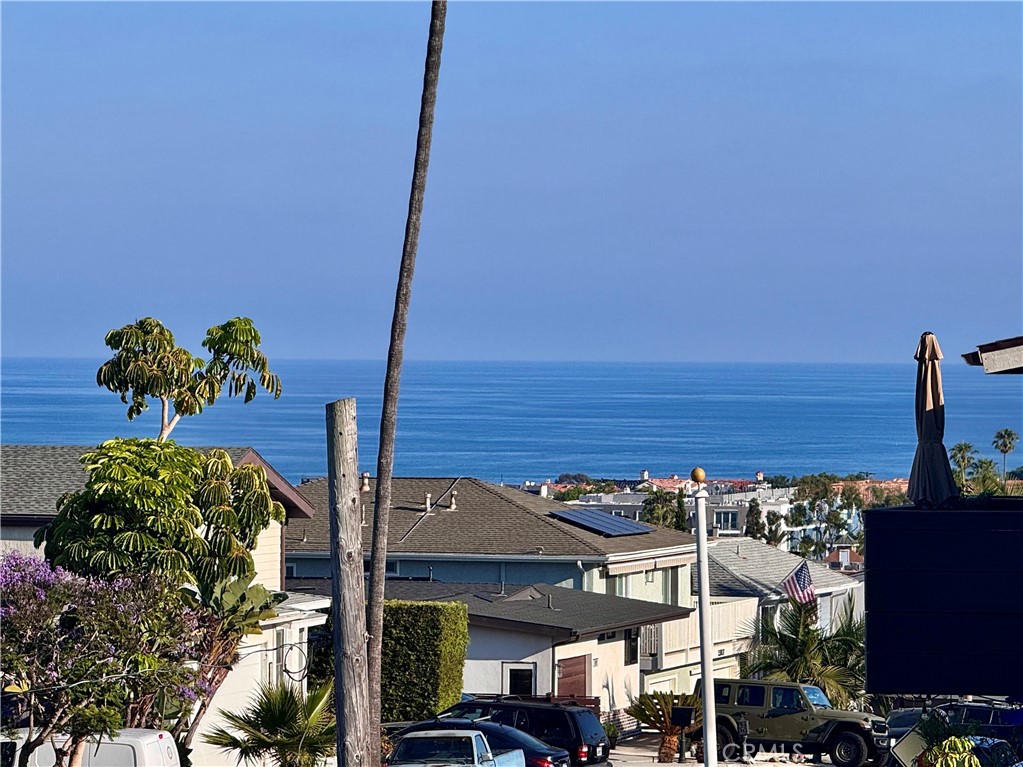 Completely remodeled with ocean views! Experience coastal living at its finest in this beautifully remodeled, turnkey townhome nestled in the heart of Dana Point. Spanning 1,387 square feet, this 2-bedroom, 2.5-bath residence has been thoughtfully redesigned from top to bottom with modern finishes and designer touches throughout. The reversed floorplan features the main living areas upstairs, where a bright and open layout showcases new luxury vinyl plank flooring, a completely remodeled kitchen, and expansive windows that frame tranquil ocean views. Downstairs, you’ll find two generously sized bedrooms, including a luxurious primary suite with a stylish en-suite bath and private access to downstairs patio. The secondary bedroom also has en suite bathroom with stylish tiled walls and new vanity and quartz countertops. Located near the bedrooms is a conveniently located in-unit laundry room. Every inch of this home has been upgraded, including a brand-new AC system for year-round comfort. The newly tiled bathrooms, sleek fixtures, and contemporary cabinetry elevate the overall aesthetic, blending comfort with sophistication. This unit has already been repiped with PEX piping as well. Ideally located just minutes from Dana Point’s beaches, harbor, restaurants, and shops, this turnkey townhome offers a rare opportunity to own a stylish coastal retreat ready for immediate enjoyment.