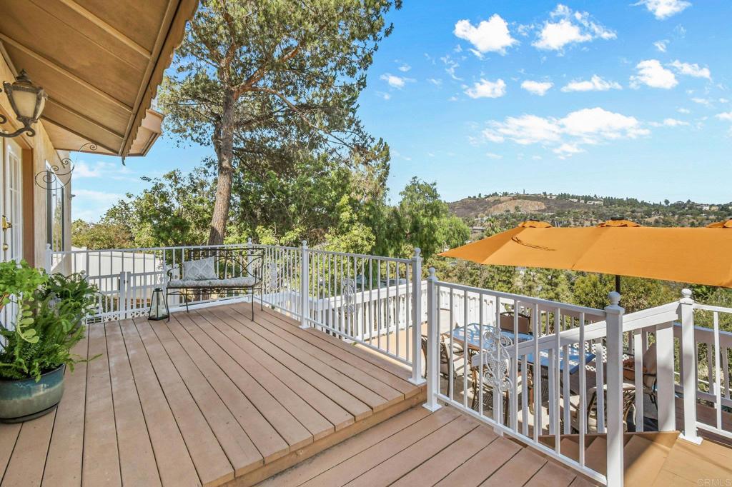 Enjoy stunning views of Cowles Mountain and breathtaking sunsets from this beautifully updated home, filled with thoughtful upgrades, relaxing outdoor spaces, and flexible living spaces. 3 spacious bedrooms, 3 newly renovated bathrooms, and spacious upper floor office, laundry room, and bonus room. The house boasts fully paid solar panels (17) and a new roof with transferable warranty, a tankless hot water heater and an energy-efficient mini split AC/heating system that utilizes the solar for year-round savings. The outdoor living spaces make this house ideal for rest and relaxation. Starting with the sparkling pool with a brand-new vinyl liner and a removable safety fence, all adjacent to a covered patio. The backyard also has mature loquat trees and landscaped gardens. The front deck is perfect for al fresco dining with room for an umbrella and patio furniture. The front lot includes a graded space ideal for play equipment, gardening, or possibly an ADU. The house has an oversized detached 2-car garage with a built-in workbench and cabinets. The concrete driveway was recently installed for decades of reliable access to your home. There is space to park an RV plus 4-5 cars outside of the garage. This move-in ready home offers a rare combination of comfort, energy efficiency, and outdoor enjoyment. With sweeping views and so many upgrades already complete, it’s ready for you to move in and make it your own.