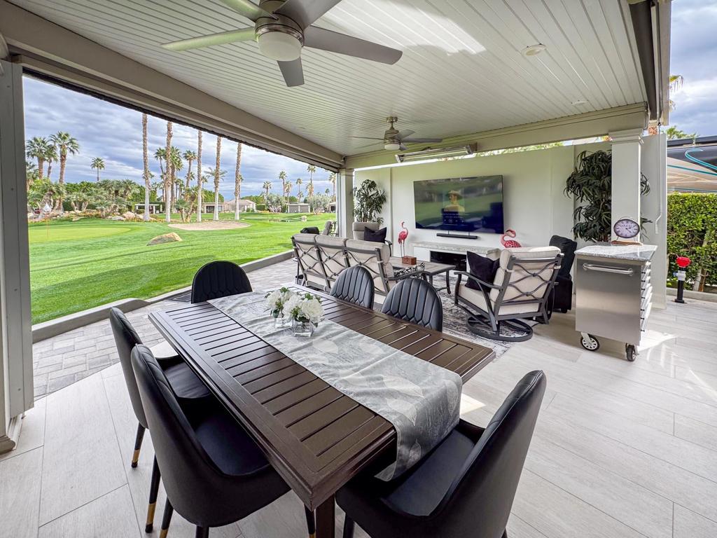 This premium luxury RV lot is a dream retreat for discerning owners, offering breathtaking eastern golf course views where you can wake up to stunning sunrises over two serene lakes and a fountain. The expansive outdoor living space is designed for both relaxation and entertaining, featuring an L-shaped pergola with a solid roof, a large gourmet kitchen with an island and six-seat bar, and upgraded stainless steel appliances, including a BBQ and beverage/wine cooler. The oversized pantry, granite countertops, upper kitchen cabinets, and tons of storage make this space as functional as it is beautiful. Manual screens along with built-in heaters and ceiling fans, provide perfect comfort, while the Alumawood construction ensures durability and style.Perfectly positioned across from the pool, laundry, and restrooms, this lot is designed for convenience and luxury. The outdoor entertainment center, complemented by two privacy walls with elegant privacy glass, creates a secluded oasis for hosting guests or unwinding in style. The tiled flooring adds a sophisticated touch, while the property accommodates a 45-foot coach with additional space for a full-size car and two golf carts. Whether you're savoring morning coffee with a sunrise view or entertaining under the pergola with a cool desert breeze, this lot offers an unmatched blend of comfort, elegance, and resort-style living.‍Outdoor Resort Indio is a Class A only RV resort in Indio, CA.
