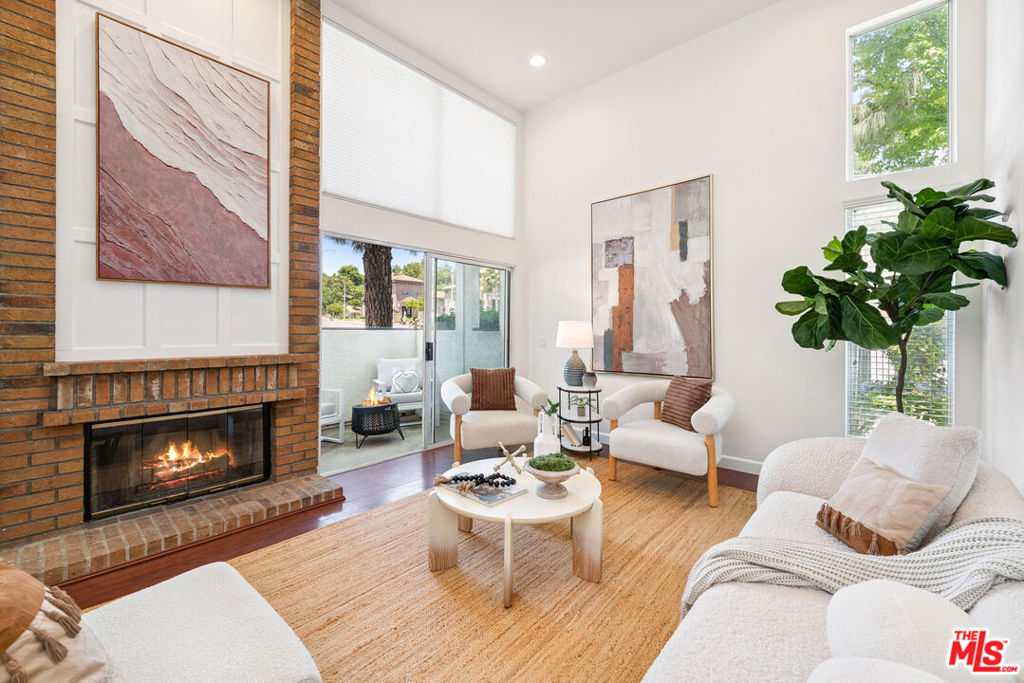 Nestled among the rolling hills of scenic Calabasas, this stunning townhouse offers an unparalleled blend of modern luxury and serene natural beauty. Spanning over 1,700 square feet, this move-in-ready corner unit in one of Calabasas' most coveted communities boasts 3 bedrooms, 2.5 bathrooms, and an abundance of natural light streaming through oversized windows, creating a bright and inviting atmosphere. Step into the formal living room, where soaring ceilings and a breathtaking brick-and-wood-lain fireplace set the stage for cozy evenings or elegant gatherings. The open layout flows seamlessly into a dedicated dining area, perfect for hosting dinner parties, and an updated chef's kitchen. Outfitted with sleek stainless steel appliances, the bright eat-in kitchen is ideal for both casual meals and entertaining guests. A convenient powder room on the main level adds to the home's thoughtful design. Just upstairs, the spacious primary suite is a true retreat, featuring vaulted ceilings, a generous walk-in closet, and a well-appointed en-suite bathroom. Two additional bedrooms offer ample space for family, guests, or a home office. Modern upgrades, including updated electrical systems and a finished two-car attached garage with direct access and laundry hookups, ensure comfort and convenience. Resort-style community amenities elevate your lifestyle with access to two sparkling pools and rejuvenating spas. The HOA covers water, trash, earthquake insurance, roof maintenance, landscaping, and shared amenities, providing peace of mind and low-maintenance living. With no neighbors above or below, this home offers privacy and tranquility. Ideally located with easy access to Las Virgenes Road and the 101 Freeway, you're just minutes from award-winning schools in the Las Virgenes Unified School District, The Commons at Calabasas, Warner Center, luxury shopping, top-rated gyms, dining hotspots, and scenic hiking and biking trails. A short canyon drive takes you to Malibu's iconic beaches and Pepperdine University, while Westlake Village and Erewhon are also within easy reach. This beautifully updated townhouse is a rare opportunity to experience the best of Calabasas living where natural beauty, modern convenience, and a vibrant community converge.