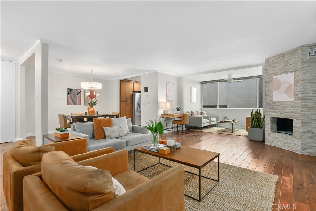 Experience the best of Santa Monica living in this stunning 2-bedroom, 2-bath modern updated SINGLE STORY condo just two blocks from Ocean Avenue which has breathtaking Pacific Ocean views. Spanning 1,369 sq ft on a single level, this open-concept home offers a seamless flow from the spacious living room — featuring rich hardwood floors and a sleek stone-finished fireplace — into the dining area, perfect for entertaining. A versatile den/flex space is bathed in natural light from large windows, offering the perfect spot for a home office or reading nook. The kitchen is beautifully appointed with tile floors, caesarstone countertops, and high-quality stainless steel appliances, including a brand-new dishwasher. The expansive primary suite is a true retreat, complete with a walk-in closet, an additional closet, and a luxurious en-suite bathroom boasting dual sinks and premium finishes. A nice sized guest bedroom and a stylish second bathroom complete the layout. Enjoy the amenities, including an inviting pool, two assigned parking spaces, and an individual storage cabinet. HOA dues cover water, sewer, trash, building maintenance, and insurance (including earthquake insurance). All of this, just moments from Santa Monica Beach, the 3rd Street Promenade, Montana Avenue shops and dining, the famed Santa Monica Stairs, and within an award-winning school district.