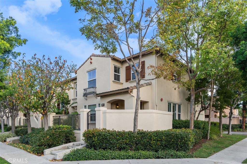Located in the desirable Trailing Vine community, this bright end-unit former model townhome offers 3 bedrooms, 2.5 baths, and tasteful upgrades throughout. Enter through a private gated courtyard into a home featuring hardwood flooring on the first floor and brand-new vinyl upstairs. The living room includes a cozy fireplace, recessed lighting and plantation shutters, while the light-filled kitchen boasts stainless steel appliances and a large corner window. A stylish half bath with pedestal sink and a separate laundry area complete the main level. Upstairs offers a spacious loft/office with built-in desk, two secondary bedrooms, and a primary suite with mirrored wardrobe and en suite bath. Additional features include a two-car attached garage, Conveniently located near the 5 Freeway, grocery stores such as Trader Joe’s, Ralphs, and Mitsuwa, popular restaurants, and top-rated Tustin Unified schools including Hicks Canyon Elementary, Orchard Hills Middle, and Beckman High. Refrigerator, washer and dryer included.