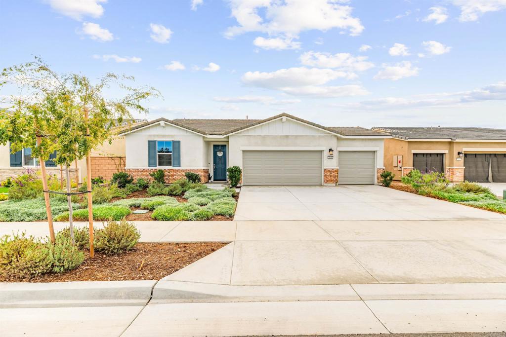 Built in 2023, this stunning single-level home offers modern comfort, efficiency, and style throughout its 1,948 sq. ft. of open-concept living space. Situated on a 6,098 sq. ft. lot, the property features 3 bedrooms, 2 bathrooms, and a 3-car garage with an EV charging port.  The spacious interior boasts laminate hardwood flooring throughout, custom tile in bathrooms, and extensive windows that fill the home with natural light. The gourmet kitchen is equipped with granite countertops, an oversized 11’ x 3.75’ island, walk-in pantry, and ample cabinetry and storage. Stainless steel appliances—including refrigerator, gas range and oven, built-in microwave, and dishwasher—are all included.  The primary suite features a walk-in closet and luxurious en suite bathroom with dual sinks, separate water closet, and full tub/shower. Additional highlights include a large laundry room with pantry shelving (washer and dryer included), central air and heat, tankless water heater, solar panels, built-in lighting with dimmers, fire sprinklers, and Fire/Carbon Monoxide alarms.  Enjoy outdoor living in the fully fenced backyard with 6’ vinyl fencing and a covered patio with ceiling fan.  Located in a clean and quiet 2-year-old community, residents enjoy resort-style amenities, including an Olympic-size pool with handicap access, jacuzzi/spa, clubhouse with kitchen, fire pit, BBQ area, family game zone, playground, and well-lit streets.  Move-in ready and beautifully maintained—this home blends luxury, efficiency, and community living at its finest!