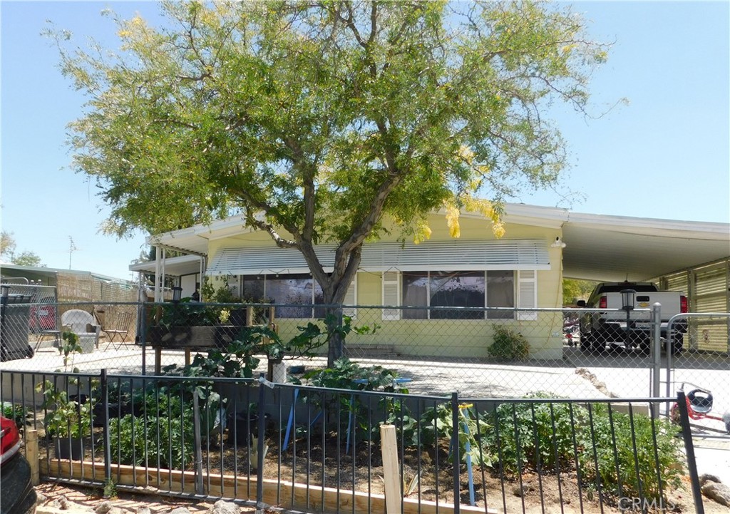 An affordable option to own your home. Home has two bedrooms with full baths attached. Large living-dining room. Family room and 3-season enclosed patio. Laundry room/ mudroom. Covered carport. Large lot with plenty of room for your outdoor hobbies. Storage room and fenced dog pen. No space rental, natural gas and city water & sewer.