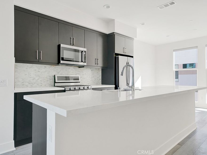 Experience modern coastal living in this newer, energy-efficient townhome nestled within the sought-after 17 West community. Designed with contemporary style and thoughtful functionality, this residence boasts high ceilings, an open-concept main living area, and a versatile ground-level office or creative space complete with an ADA-compliant restroom.



Built for comfort and sustainability, the home features advanced energy-saving elements including foam insulation, dual-pane Low-E windows, high-efficiency HVAC, a tankless water heater, and LED lighting throughout.



Residents of 17 West enjoy access to an array of lifestyle amenities, gather with neighbors around the fire pits, host weekend barbecues, or play a round of bocce ball, all just steps from your door. Ideally situated in the vibrant heart of Costa Mesa, 17 West offers unparalleled convenience with premier dining, shopping, and parks nearby. All with the added bonus of having access to the beach just over a mile away.
