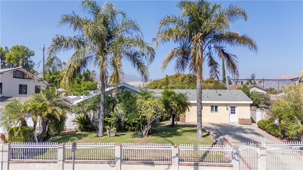 This centrally located Pacoima gem offers incredible flexibility and income potential with three separate living spaces perfect for any savvy investor! Here are just a few of the 11044 Borden Ave many other fine features: Ornate wrought iron/brick capped stucco pillar fencing, lush landscaping, and swaying palm trees enhance its eye-catching curb appeal. You’ll step into a flowing open concept floor plan that is in “Move-In-Condition” with elegant crown molding and easy care tile and laminate flooring. Spacious living room. The family’s cook is going to truly appreciate the kitchen’s Abundant cabinets, ample granite counters with full back-splash, center island, durable dual basin stainless steel sink, built-in appliances, and the convenience of the adjoining dining area with direct patio access. 3 bedrooms. 2 bathrooms. Energy efficient dual pane windows will help keep your utility bills low and the interior very quiet. Central air & heat The attached rear addition offers: A flowing 483 square foot floor plan in with durable tile flooring, 2 bedrooms, 1 bathroom. Dual-pane windows 11042 Borden Ave features: A dedicated entrance opens to 466 square feet of living space with a mix of tile and laminate flooring. Nice kitchenette with an efficient ceiling fan. 2 bedrooms. 1 bathroom. Tank-less water heater. Dual-pane windows. The addition and ADU are perfect for a multi-generational family, while the permitted ADU could provide rental income to offset the mortgage. A total of 2,440 square feet of living space. Plenty of off street parking behind the rolling security gate. All of this sits on a large 8779 square foot lot that’s close shopping, restaurants, schools, Costco, and Hansen Dam Recreation Area with its Golf Course and comprehensive sport amenities and activities. This rare 3-unit opportunity won’t last long so call me today for all the details and I’ll gladly arrange your private tour.