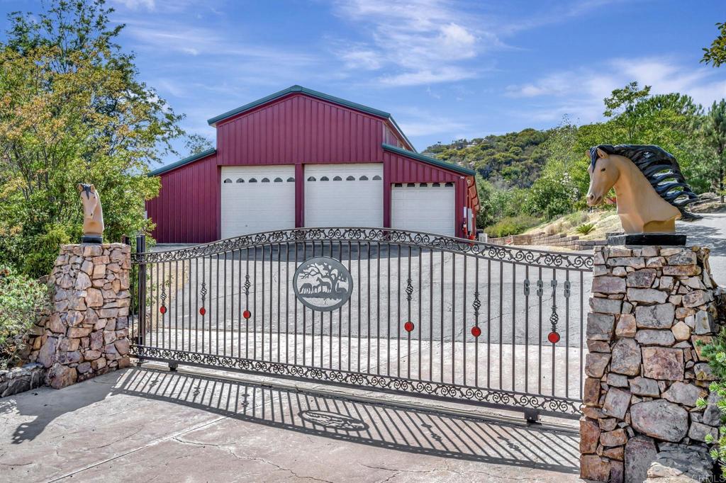 Welcome home to this absolutely breathtaking gated horse property with 9 acres of highly developed and maintained usable land nestled in the hills of Alpine!!! Just 5 minutes off the 8 freeway enter the gates to enjoy an absolute piece of heaven! Once you enter the gates you will not want to leave! Panoramic gorgeous views, water & electricity throughout the land, completely fire compliant including sprinkler system and hydrant hoses, 2 acre pasture, 5000 sq ft barn with built in space, control room, office space to run the ranch and indoor/outdoor stables, riding arena, corrals and secret gardens! Many trails to enjoy horseback in the hills and valley! The interior of this home has stunning Brazilian cherry wood long plank wood floors & travertine marble floors, a gorgeous gourmet kitchen with alder wood custom cabinetry, Dacor 6 burner stove, walk in pantry, Yotel wood burning stove, a beautiful great room with stunning views through large picturesque windows and a beautiful rock wall adorned with a wood burning fireplace, 2 central heat and AC systems, 2937 sq ft, 4 bed/3 ba with additional library/study that has it's own entrance, open beam cedar vaulted ceilings, shooting range, 440 fencing, 5 minutes from the 8 freeway, great producing gravity fed well and large storage tank. Complete generator back up system for the house and barn also conveys with the ranch. Truly one you do not want to miss!!! Full ability to ranch and farm here at this property!!! Come and take a look at this beauty making sparks in our market today!!! Your memories are next to make here!!!