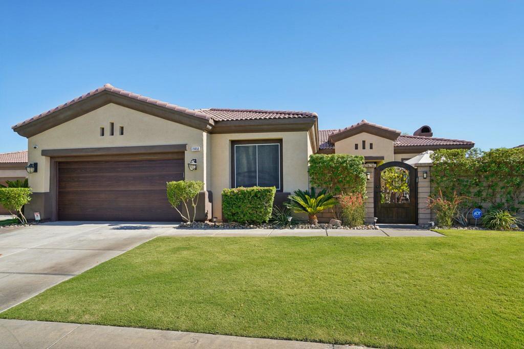 Welcome to Your Dream Home in the highly sought after Esplanade Community! Discover luxury desert living in this exceptional 2,436 sq. ft. residence, perfectly situated in North La Quinta. This beautifully designed home seamlessly blends comfort and modern versatility, making it ideal for a wide range of lifestyles. Boasting 4 spacious bedrooms, 3 full bathrooms, and a flex room that would be perfect for a home office, gym, media room, or even a 5th bedroom. As you enter through the custom gated courtyard, you'll immediately feel a sense of calm and privacy, perfect for morning coffee, reading, or evening gatherings. Inside, the open-concept layout connects the living, dining, and kitchen areas, creating a warm and inviting environment ideal for both everyday living and entertaining. The Gourmet Kitchen Features an Expansive island with seating, a Double oven, 5 Burner Gas Cooktop, Abundant cabinetry, Built-in coffee bar with mini fridge and floating shelves. A true chef's kitchen ready for your culinary delights and social gatherings. The recently remodeled primary bathroom has a spacious walk-in closet. When you step into the private backyard paradise designed for year-round enjoyment, you will find a Pebble Tec pool and spa, an Outdoor kitchen with pizza oven, built-in BBQ (with a burner), Mini refrigerator, and ice holder. There is also an area for your furry friends. Additional Upgrades & Features include the Private Courtyard with Pavers and Custom Gate, a Custom Garage Door, Misting System (for those hot desert days), and a drip system in the front and back. This home captures the very essence of indoor-outdoor desert living in one of La Quinta's most desirable communities. Whether you're entertaining guests or enjoying quiet time under the stars, every detail of this home is designed for comfort and style. Don't miss this opportunity! Schedule your private showing today and experience the best of Esplanade living!