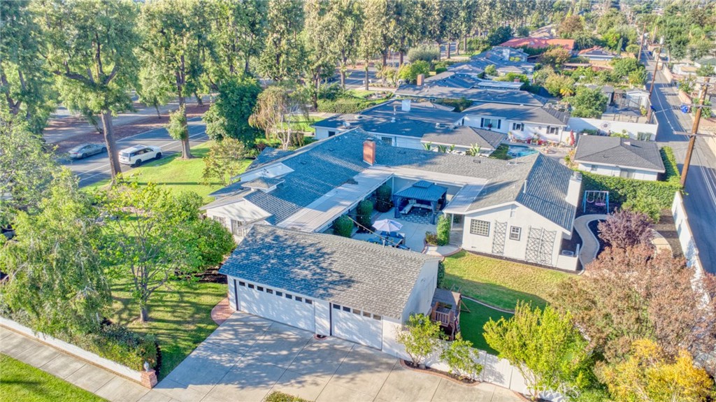 Welcome to this gorgeous, freshly painted exterior ranch style home on an over 17,650 sqft lot in the heart of Upland. Upon arrival an exceptional curb appeal and beautiful brick walkway leads directly to the inviting front porch. Inside, 3,500 sqft of living space with 5br. 4 1/2 bath. Natural vinyl flooring and an open layout ensure easy movement between rooms, along with an abundance of natural light. The kitchen is designed for both functionality and style, ample cabinet space, quartz countertops with elegant backsplash. It is equipped with a white farmhouse sink, stainless steel countertop burner, built-in oven and microwave, Bosch dishwasher, Samsung refrigerator, and a wine cooler. Under-cabinet lighting adds convenience and visibility. A separate laundry area is situated nearby for additional practicality. The kitchen also includes a breakfast nook and bar seating, perfect for casual meals. The adjacent formal dining area is appointed with a built-in China cabinet and connects seamlessly to the formal living room, which is centered around a fireplace and bookcase, and features French doors that open to a courtyard, providing effortless indoor/outdoor access. The home is designed to offer comfortable living and entertaining spaces for both everyday life and special occasions. The primary suite has its own private retreat, complete with a dedicated room featuring a fireplace and bookcase. It offers walk-in closets with custom organization systems and vanity. The suite includes a large shower, spa-style bathtub, and direct access to the central courtyard, creating a relaxing and luxurious environment. Secondary bedrooms are generously sized and feature ceiling fans, recessed lighting, and walk-in closets. Two of the bedrooms include in suite bathrooms for added comfort. An additional full bathroom is in the hallway, while having additional powder room. The central courtyard and porch area, which is enhanced by a built-in gazebo and a landscaped backyard, ideal for gatherings and outdoor activities. The property further includes, updated air conditioning, and smart switches enabling remote lighting control. Fruit trees, a children's play area, and proximity to shopping, dining, schools, walking trails, and freeway access add to the home's appeal.