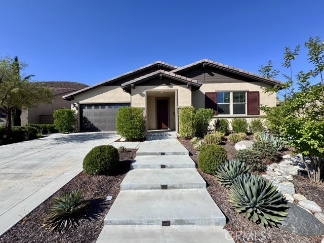 Welcome to this stunning 4 bedroom, 2.5 bathroom single story home located in the gated Province community within Audie Murphy Ranch in Menifee! This beautifully maintained home offers great curb appeal, a two car garage, a spacious and functional layout, and a meticulously landscaped backyard perfect for year-round enjoyment. Available for immediate move-in! Upon entry, you're welcomed by a light and neutral paint scheme, complemented by rich plank flooring. Just off the entry is a generously sized bedroom with a walk-in closet and an adjacent half bathroom making it ideal as a guest room, office, or private retreat. Continuing through the home, you’ll find two additional spacious bedrooms, both featuring walk-in closets and sharing a full bathroom with dual sinks and a tub shower combo. The heart of the home is the bright and airy family room, filled with natural light and open to the gourmet kitchen. The kitchen features white cabinetry, granite countertops, an oversized island with bar seating, stainless steel appliances, a walk-in pantry, and an adjoining dining area, perfect for entertaining or everyday living. The primary suite is tucked just off the family room and offers a generous layout with an ensuite bathroom that includes dual sinks, a soaking tub, a separate walk-in shower, and an expansive walk-in closet. Venture outside to enjoy the beautifully designed backyard, complete with a large covered patio, an additional open patio area, a built-in firepit space, BBQ, artificial turf, a spacious side yard, and lush landscaping. Residents of Audie Murphy Ranch enjoy exceptional amenities, including a resort-style pool and spa, clubhouse, walking trails, playgrounds, sports courts, and more. Conveniently located near schools, freeway access, shopping, and dining. Don’t miss your chance to lease this incredible home, schedule your showing today!