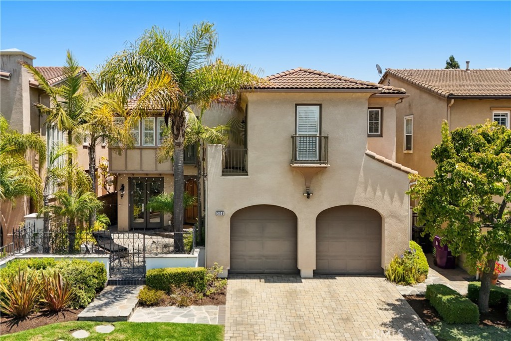 Mediterranean Warmth Meets Modern Living in Alamitos Heights
Live the Southern California dream in this reimagined Mediterranean-style residence tucked into the sought-after Bayshore community of Alamitos Heights. Offering timeless curb appeal and elegant updates throughout, this four-bedroom, four-bathroom home blends classic design with modern comfort just moments from the beach, Belmont Shore, and Marina Vista Park.
A striking arched wood door framed by lush palms and wrought iron accents opens to a serene front courtyard, setting the tone for this beautifully curated coastal retreat. Inside, a sweeping curved staircase welcomes you into a bright and airy interior with refined finishes and abundant natural light. The open concept layout features a custom fireplace, built-in cabinetry, and expansive windows with plantation shutters. The dining area and chef’s kitchen connect effortlessly to the private backyard, where string lights, mature landscaping, and a shaded patio create the perfect space for entertaining.
Upstairs, each bedroom features its own en suite bathroom, including a spacious primary suite with a walk-in closet, steam shower, and soaking tub. A versatile downstairs bedroom and full bath provide an ideal setup for guests or a home office. Throughout the home, thoughtful details like designer lighting, wood floors, and warm natural textures elevate the living experience.
Located near top rated schools, the marina, shoreline walking paths, and local dining favorites, 304 Winslow Avenue captures the best of modern Mediterranean living in one of Long Beach’s most desirable neighborhoods.