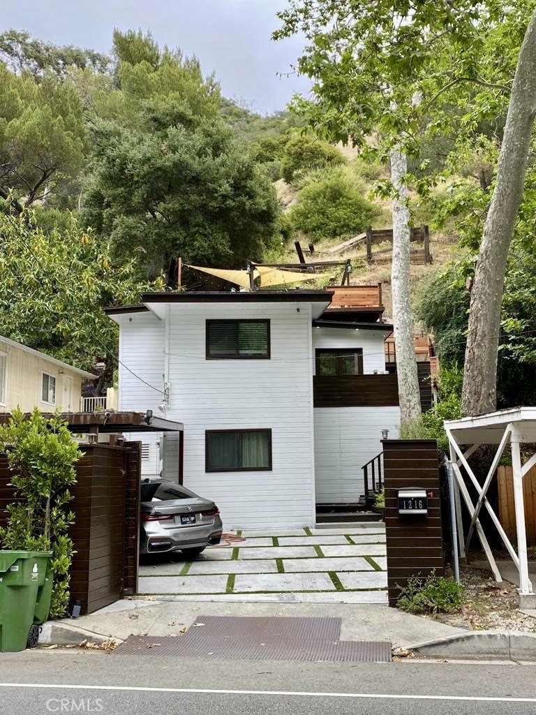 Welcome to this delightful single-family home in the sought-after Beverly Glen neighborhood of Los Angeles. This cozy 2-bedroom, 1-bathroom home offers 1,081 square feet of living space, combining comfort with practicality. Highlights include a gated entrance for added privacy, a spacious outdoor area with concrete pavers and lush greenery, and a modern kitchen with white cabinets and stainless-steel appliances. The inviting living room features a decorative fireplace and large windows that let in plenty of natural light. Additional conveniences include a washer and dryer, central heating and cooling, a dedicated parking space, and an outdoor deck perfect for gatherings. Pets are welcome, making this a great home for animal lovers. Located close to restaurants, schools, and hospitals, this home is in an unbeatable spot. Schedule your showing today!