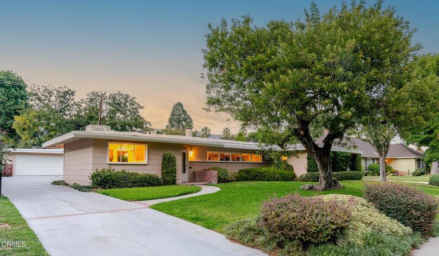On the market for the first time in over 50 years, this beautifully designed and well-maintained mid-century home is a one-of-a-kind Pasadena treasure. Boasting natural light throughout, ample space for entertaining, character details, and close proximity to Caltech, Huntington Gardens, and South Lake Avenue, this residence offers the best of both classic charm and modern convenience. As you enter, the living room welcomes you with its striking brick fireplace surrounded by windows peeking into the sunroom just beyond. This dreamy room is the perfect place to entertain, relax, or work from home, with sliders opening to the back patio and a convenient tucked-away laundry room. The formal dining room accommodates both large parties and intimate gatherings and features a custom built-in sideboard & cabinetry for your china and glassware. The kitchen provides abundant counter space, plentiful cabinetry, dual ovens, a prep sink, and a sun tunnel that fills the space with light. On the east wing, two guest bedrooms with large closets provide flexibility for restful retreats, a home office, or space for hobbies, while the primary suite offers an ensuite bath featuring a separate shower and tub. Outside, enjoy an oversized patio ideal for dining al fresco, a large grassy yard with privacy hedges, and a detached two-car garage with workshop. Don't miss this rare opportunity in one of Pasadena's most prestigious neighborhoods.