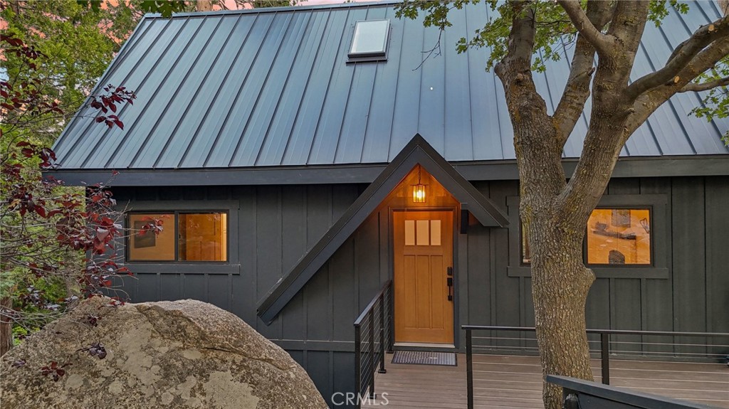 Stunning Fully Renovated Lake Arrowhead Home with Lake Rights & Unobstructed Views, including Blue Jay Bridge! This incredible home has been completely rebuilt down to the studs with over $400,000 in top-quality upgrades—designed to be fire-wise, energy-efficient, and low-maintenance, while offering modern comfort and timeless mountain charm. Go inside to find an open floor plan with Bellawood white oak engineered wood flooring, a beautiful German Schmear fireplace, and panoramic views from every angle. The chef’s kitchen boasts marble counters, induction stove (gas hookup available), retro fridge, drawer microwave, and custom cabinetry. Bathrooms are elegantly designed with Delta split-control rain showers, sleek fixtures, and thoughtful details. No expense was spared in making this a turnkey, worry-free mountain retreat. Upgrades include: Solid-core knotty alder doors and trim, Nu-Ray 24-gauge metal roof with 8" foam insulation & skylight (50-year rated), Hardi board & batten siding, pre-painted for long-term durability, Milgard C650 fiberglass windows & patio doors, Timbertech Class A fire-rated decks with View Rail railings, PEX plumbing with Moen Flo smart water shutoff, 220 amp panel with updated electrical & lighting, HVAC with multi-zone Ecobee controls, Navien hydronic furnace & GE Connect AC, Whole home generator for peace of mind. The exterior is equally impressive with new retaining walls, French drains, plus the spacious deck perfect for enjoying the fresh mountain air and sweeping views. Located just minutes from Lake Arrowhead Village, Blue Jay, and the lake itself, make it the ultimate full-time residence, weekend escape, or investment opportunity. The property is located in an area with underground utilities lending a cleaner aesthetic with no overhead wires. A rare chance to own a fully reimagined mountain retreat where every detail was designed for beauty, safety, and ease of living.