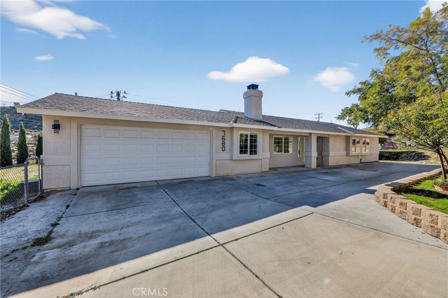 Fully remodeled 3-bedroom, 2-bathroom home offering over 1,500 sq. ft. of living space on an expansive 25,000+ sq. ft. lot. This move-in-ready property features leased-to-own solar panels, a 2-car attached garage, and additional driveway parking.

Inside, enjoy newly installed laminate flooring, fresh interior paint, recessed lighting, central A/C and heat, and dual-pane windows throughout. The spacious living room is highlighted by a stunning brick fireplace, creating a warm and inviting atmosphere.

The breathtaking new kitchen showcases glossy finish cabinetry, quartz countertops with a waterfall edge, stainless steel appliances (all included), and modern fixtures. Both bathrooms have been newly remodeled with elegant vanities and LED mirrors.

Additional conveniences include an in-home washer and dryer. Step outside to a serene backyard featuring a brick fire pit, ample space for entertaining, storing recreational toys, or hosting large gatherings. This property offers the perfect blend of modern upgrades, functionality, and outdoor space.