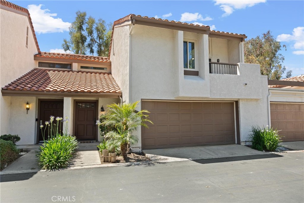 Welcome to this beautiful upgraded 3 bedroom 2.5 bathroom townhome located in the heart of Mission Viejo. This charming tri-level property boasts a thoughtfully designed floor plan with an abundance of natural light and multiple fantastic patios. The home features a modern kitchen with granite counter tops and a breakfast bar. The spacious living room includes a cozy fireplace, creating a warm and inviting atmosphere. All three bedrooms are generously sized, offering plenty of space for comfort and convenience. Recent upgrades include newer carpet and paint throughout, enhancing the home's appeal. The ceilings have been scraped for a contemporary look, and the full-size laundry room adds to the home's functionality. Parking is a breeze with a large 2-car attached garage and an additional assigned parking space #43. Enjoy the serene greenbelt views and take advantage of the great location, which is conveniently close to everything you need. This wonderful townhome is available now.