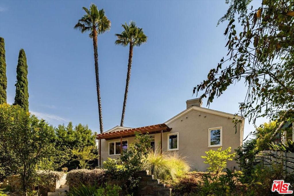 Perched atop a hill in Eagle Rock, you'll find this enchanting Traditional circa 1942, with charm and an elegant flair. Sited on a gracious lot, upon entry through the front gates you're greeted by a peaceful oasis with a waterfall pond, fruit trees, and native landscaping. Inside, a hallway leads to the alluring primary suite which was completed in 2022 and boasts custom built-in closets, and an oversized bathroom drenched in sunlight streaming through skylights. The living room is warm and cozy with wood floors leading you across a curved wall and into the dining area framed by original built-ins. The kitchen and laundry room whisper a playful charm, while honoring classic design features. Two bedrooms and a guest bath complete the thoughtful floor plan maximizing every square foot. Access the backyard from the dining area to your custom deck perfect for entertaining and relaxing behind your lush and private landscaping. From the front to the back you get a true sense of LA's natural beauty, enveloping the home. Finally, a large detached garage provides a likely opportunity for a future ADU. This prime Eastside location offers easy proximity to some of the hottest spots on York such as Queen's Raw Bar, Loquat, and Fondry, while still feeling away from all the hustle and bustle in a sanctuary created and now offered to you.