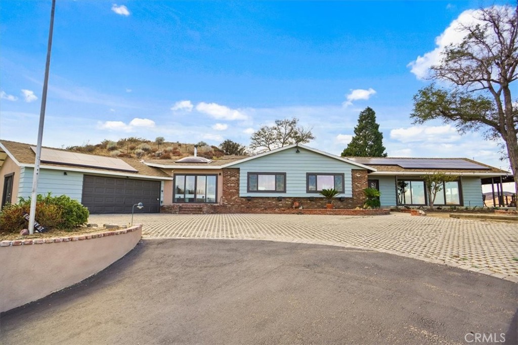 Enjoy breathtaking, unobstructed views from this beautifully remodeled 4-bedroom, 3-bath home set on 2.48 private acres in the serene community of Leona Valley. Just 10 minutes from Palmdale and the 14 Freeway, this retreat combines modern upgrades with warm, inviting character.
Inside, the open-concept great room showcases a brick fireplace spanning the full wall, open-beam ceilings, new wood-look flooring, and expansive windows that frame the valley views. A set of sliding glass doors leads out to the covered patio and BBQ area—perfect for entertaining or simply relaxing.
The chef’s kitchen features new Craftsman-style cabinetry, rich quartz countertops, a stainless steel farm sink, and high-end stainless steel appliances, including a designer hood.
The luxurious primary suite feels like a boutique hotel, offering a spacious walk-in closet with frosted glass barn-style doors, skylights, a freestanding soaking tub, a stone-floor walk-through shower, and a cozy woodstove for cool evenings.
Additional highlights include three spacious secondary bedrooms, two stylishly remodeled baths, a barn for animals or projects, and an extra storage shed.
Private yet accessible, this move-in ready home is a rare opportunity to own your piece of paradise in Leona Valley.