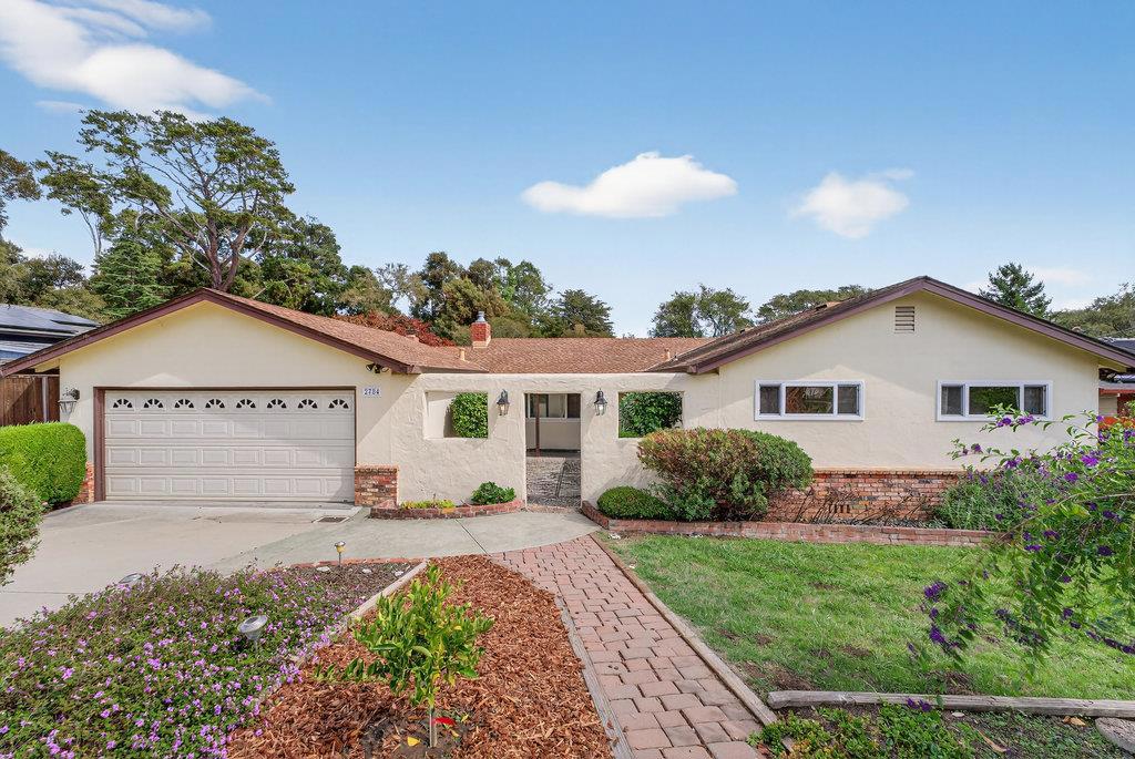 Welcome to this charming home located in the vibrant coastal community of Aptos. This home is only a 15 minute walk from Cabrillo College! This spacious residence boasts four bedrooms and 3 full bathrooms, offering ample space for comfortable living. It is also located on nearly 1/2 acre of land with plenty of room and an expansive deck to enjoy the outdoors. Enjoy meals in the open dining/living room area or relax in the separate family room, perfect for gatherings. The living and family rooms both feature fireplaces. The home features a mix of carpet, hardwood, and vinyl/linoleum flooring, adding variety and style to each room. Stay cozy during cooler months with the fireplaces and forced air heating, while ceiling fan provide cooling options in warmer seasons. Set within the Pajaro Valley Unified School District, this property offers proximity to local schools. With 1,957 square feet of living space, this home provides both comfort and functionality. The attached two-car garage adds storage and parking convenience. There is even RV parking next to the garage. PLEASE NOTE: Some photos have been virtually staged.