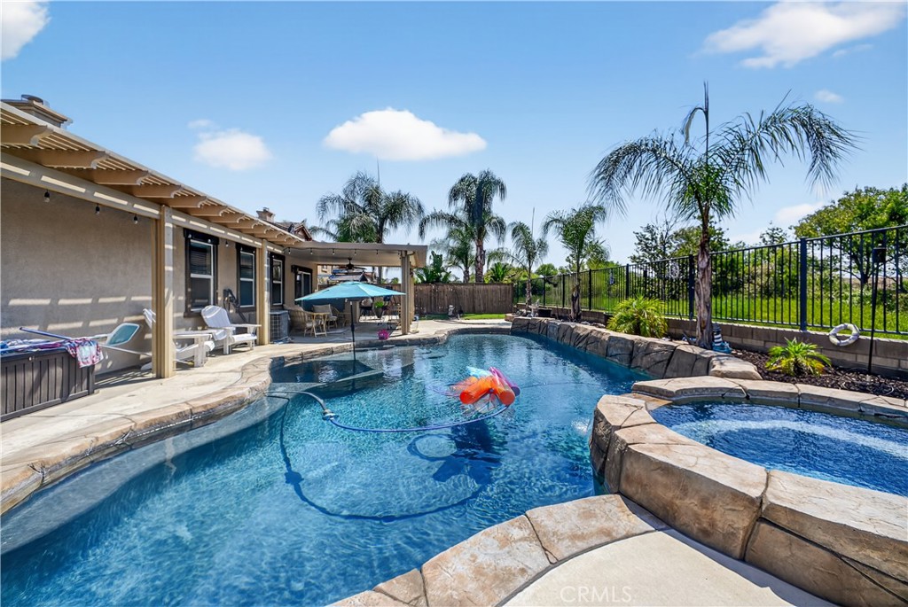 Welcome to 33672 Magnetite Street, a single-story gem located in the heart of Menifee. This spacious home offers a rare opportunity to create your dream retreat, featuring an inviting in-ground pool and hot tub perfect for relaxing or entertaining. The covered outdoor patio provides a comfortable space to enjoy warm California evenings, and with no rear neighbors, you'll enjoy added privacy and peaceful views. For those with toys or extra vehicles, the generous RV parking is a huge plus. While the home could use a little TLC, it’s full of potential and ready for someone to make it their own.Don’t miss out on this unique opportunity in a desirable Menifee neighborhood.