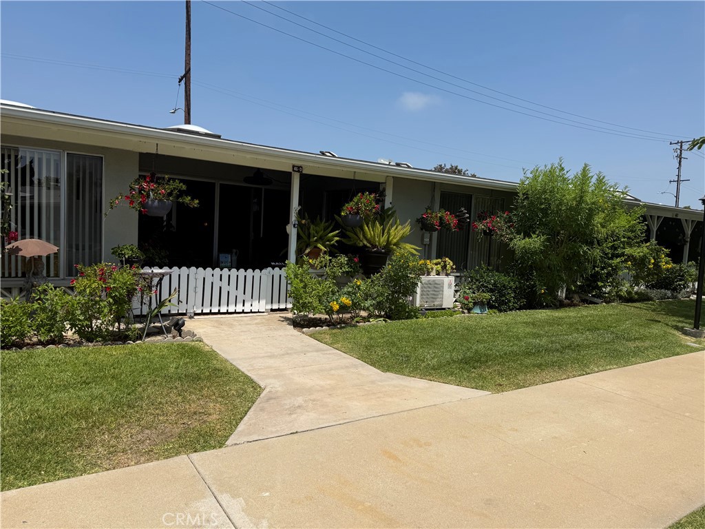 Take a look at this amazing two bedroom, 1 bathroom home located on a dramatic green belt enhanced with beautiful trees and greenery. This inviting home has a spacious living room featuring a skylight, heat pump, and sliding glass doors to a charming patio. The dining room extends to the sitting area that overlooks the greenbelt. The kitchen has built-in appliances including a dishwasher, microwave, added skylight, quartz counter tops and an island with extra storage. The main bedroom has a walk-in closet, an additional second closet, and a sliding door to the patio. The bathroom has a washer/dryer, quartz counters, a cutdown shower for walk-in convenience, and a skylight. The second bedroom has a skylight and a wardrobe closet. Additional features are ceiling fans in in the dining room, kitchen, and bedrooms, and deluxe vinyl plank flooring throughout.