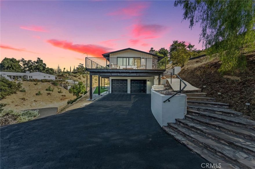 Welcome to this beautifully upgraded, fully renovated mid-century modern home in the heart of South Redlands. As you approach, a long turnaround driveway leads you to a spacious residence designed for multi-living with two individual living areas, offering the perfect balance of comfort and functionality. Inside, the open-concept design with exposed beams invites natural light to flood the home. The seamless flow from the entry to the living room, dining room, and kitchen makes it ideal for both daily living and entertaining. The updated kitchen is equipped with quartz countertops, a Sub-Zero refrigerator, and a Viking professional stove/oven, opening to the dining and living areas. The primary bedroom serves as a private retreat with stunning views, a luxurious ensuite bathroom with a walk-in shower and dual vanity, and direct access to the outdoor deck. Step outside onto the entertaining front large deck which is perfect for dining and enjoying the 180-degree panoramic views of the surrounding mountains, valley and golf course. With ample space for an ADU, pool, or RV parking, the expansive yard is a blank canvas waiting to be personalized to your own taste. The lower level provides a versatile second living area, complete with a private bedroom, bathroom, laundry, and full kitchen—perfect for multi-generational living, long-term guests, or additional rental income. It opens out to your outdoor entertainment space as well. Conveniently located in the highly sought-after South Redlands neighborhood, you're just a short golf cart ride away from Redlands Country Club and close to Loma Linda Medical Center, the University of Redlands, ESRI, shops, restaurants, and top-rated schools. This home offers flexibility to fit your lifestyle while capturing the essence of luxury living with spectacular views.