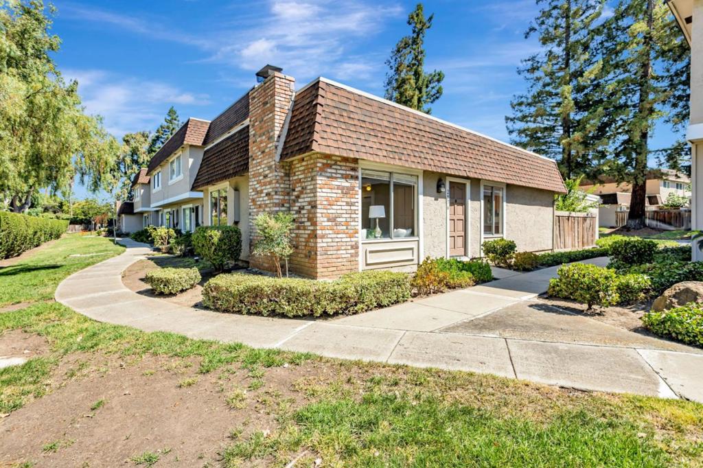 This charming single-level end-unit townhouse offers the perfect blend of privacy and convenience. Ideally located for commuters and served by excellent schools, this light-filled home features an open-concept layout, spacious bedrooms, and the comfort of indoor laundry. Enjoy an updated kitchen and bathroom, a private backyard, and a two-car garage. Nestled quietly at the back of the complex, it faces serene common areas and open space, giving it a peaceful, tucked-away feel. Note: Parking within the complex is restricted. A parking pass is required; unauthorized vehicles will be towed.