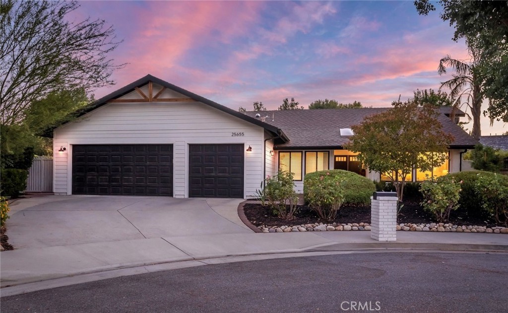 Welcome to this stunningly renovated single-story POOL home tucked away on a picturesque cul-de-sac in the heart of Valencia. Boasting 4 bedrooms, 2 baths, a versatile loft, family room with brick fireplace, and formal living and dining areas, this residence offers nearly 2,200 sq ft of stylish, open concept living. From the moment you arrive, the modern farmhouse aesthetic impresses with barn-style lighting, exposed wood accents, newer exterior paint in Swiss Coffee accented by Tricorn Black, oversized driveway, and drought-tolerant landscaping. Inside, you’re welcomed by light oak wide plank flooring, high ceilings, plantation shutters, designer lighting, inviting paint selections, and tons of windows and sliding glass doors that fill the home with natural light. The updated kitchen features freshly painted cabinetry in Accessible Beige, GE Cafe appliances, large sink, granite counters, built-in coffee bar area with statement hex backsplash, and a large island with seating for four. The spacious Primary Suite includes a walk-in closet, ambient lighting, and direct access to the beautiful backyard. The ensuite bath feels spa-like with a dual vanity with quartz counters, matte black coordinating fixtures, and a custom tiled rain shower with multiple body sprays. Two additional bedrooms offer generous space, accent lighting, and custom built-ins, while the stylishly moody den (optional 4th bedroom) features built-in shelving and a Murphy bed! This space is ideal for a home office, game room or private guest suite. A renovated hall bath features a double vanity with updated counters, new hex flooring in terracotta and designer coordinating fixtures. Don’t miss the convenient laundry area with custom wood countertop and abundant storage. The flexible loft space is perfect for a home office or reading nook complete with built in shelving and desk. Step outside to your own private retreat with a newly renovated pool and spa, expansive patio spaces, lush landscaping, and grassy areas to relax or play. Additional highlights include a 3-car attached garage, upgraded HVAC, and ample storage throughout. Ideally located near paseos, parks, award-winning schools, shopping, and easy freeway access. This home checks every box! Don’t miss it!