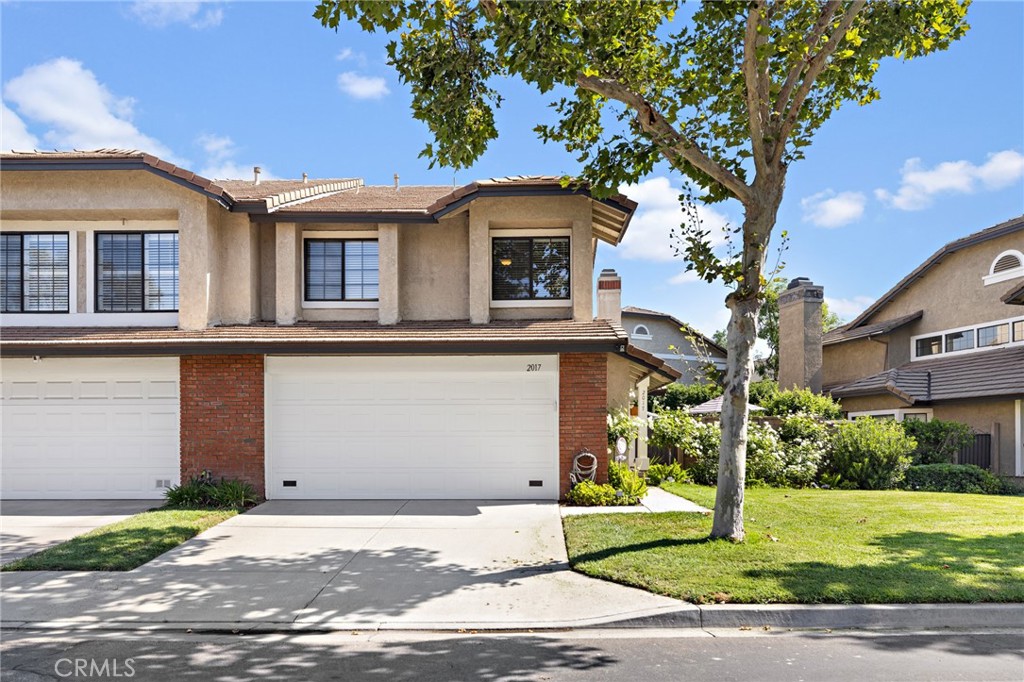 Beautiful, remodeled/updated end unit in prime location in Glendora Springs. The entry leads to living and dining room with vaulted ceiling, hardwood floors and custom window coverings. The remodeled kitchen has custom cabinets, granite counters, pantry, wine refrigerator and tile floors. Adjacent is the family room with fireplace, currently being used as dining room. The family room opens to a beautiful yard with large aluminum patio cover with TV option, ceiling fans, lights and draperies. Perfect for alfresco dining and entertaining. There is custom landscaping and artificial turf for a beautiful and easy-care yard. A remodeled half bath with tile walls, floor and granite counter and a custom wrapping closet complete the first floor. Upstairs is the large, primary suite with vaulted ceiling, mirrored wardrobe closets, chandelier and carpet. There are double sinks and a large soaking tub/shower. The additional 2 bedrooms have carpeting, mirrored wardrobe doors and window coverings. One bedroom being used as office. Closet World Design designed closet to accommodate for office use or personal use. There is a full bath with granite countertop that services the two bedrooms. Fixtures in house have been replaced including recess lighting. The HVAC and water heater have been replaced. An attached 2 car garage has direct access. The garage has storage on both walls and epoxy flooring. Unit has parking for 4 cars (2 garage, 2 driveway). Complex has heated pool, spa, restrooms, tennis/pickle ball court and manicured ground. Association dues also cover water, trash, termite, roof and exterior paint. Close access to 210 freeway, shopping, movies, restaurants and public transportation. A must see!