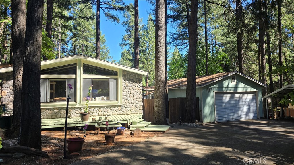 QUIET CUL-DE-SAC LOCATION WITH FULLY FENCED & GATED YARD! Large end of courtyard offers an Oversized 24x30 Garage and has a covered walkway from the house to the garage, plus a metal carport & 2 storage sheds with Plenty of RV Parking! The yard is cross fenced with a dog yard and has a great covered back porch too! Custom rock work adorns the front of this home and a covered front porch & extended patio with pergola offers wonderful outdoor enjoyment! Inside this home boasts a full wall of floor to ceiling windows in the living room that brings in tons of natural light, vaulted ceilings and a gas fireplace in the large living room. The floor plan is spacious & open with the living room flowing seamlessly to the dining room and kitchen. The kitchen has custom cabinets and ample storage & countertop space plus room for a eat-in kitchen nook. The master bedroom has daylight windows at the ceiling, full wall closet and sliding glass door out to a private, covered balcony deck. The large ensuite bathroom has another daylight window, lots of counter space & storage plus a walk-in shower with a custom etched glass door! There is a guest room & hall bath with full tub/shower enclosure, inside laundry/utility room, enclosed outside laundry room off back porch for those that don't want the laundry in the house gives you 2 options.