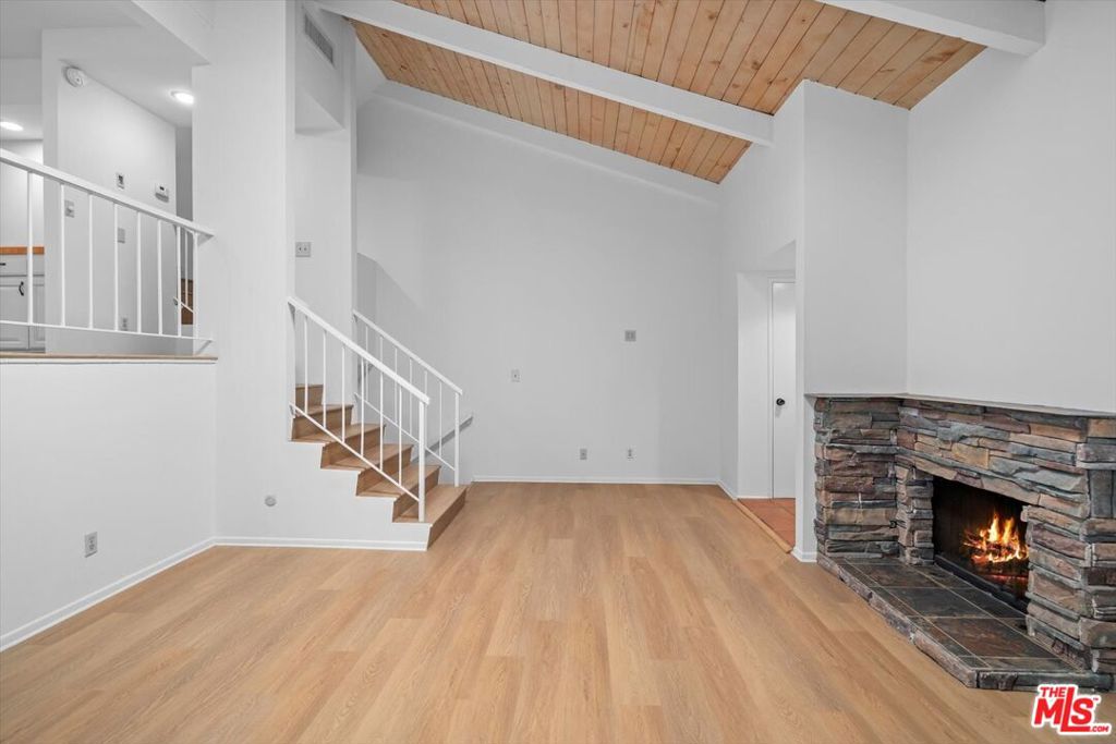 Nestled in the highly coveted and meticulously maintained Studio Village community in Studio City, this beautifully updated townhouse beckons with soaring high ceilings, pristine new flooring, and the inviting glow of a stone fireplace that defines its luminous living area. The remodeled kitchen, outfitted with gleaming stainless steel appliances, flows effortlessly into a cozy breakfast nook and a versatile den ideal for a dedicated home office or creative workspace. While a nearby formal dining room, complete with a built-in bar, sets the stage for elegant entertaining. Sunlight streams through generous windows, brightening the airy and spacious interiors, and central air conditioning ensures comfort in every season. A seamless transition leads you to a private patio, perfect for morning coffee or peaceful relaxation. A direct-access two-car garage elevates practical living. Resort-style amenities include six swimming pools, five luxurious spas, two tennis courts, and manicured landscaping. This prime location places you mere minutes from the trendy boutiques, casual cafes, and dining destinations of Ventura Boulevard. With the added convenience of nearby studios, top-rated schools, and easy freeway access, this home offers the ideal blend of sophisticated updates, thoughtful layout, and a relaxed yet upscale Studio City lifestyle. HOA includes water, internet, basic cable w/ Showtime and earthquake insurance. Fireplace is decorative. Fire was digitally enhanced.