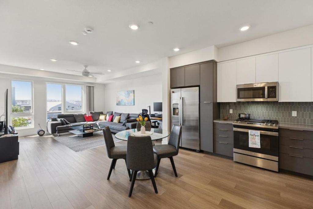Modern and meticulously maintained, this nearly new 1BD/1BA condo offers contemporary living in Fremont's premier Innovation Community. Built in 2023, the home features an open floor plan, high ceilings, abundant natural light, and a spacious private balcony ideal for indoor-outdoor living. The kitchen flows seamlessly into the main living area, while the large walk-in closet, in-unit washer/dryer, and central AC provide daily comfort and efficiency. A dedicated 1-car garage parking space with additional storage and access to EV charging stations adds practical appeal. Residents enjoy exclusive amenities including two fitness centers, a luxury lounge, swimming pool, BBQ courtyard, firepits, children's play areas, and two elegant clubhouses. The location is unbeatable: near I-880, I-680, Warm Springs BART, top-rated schools, and local parks. Just minutes away, Pacific Commons shopping center offers a wide variety of shops, restaurants, and entertainment, making this home ideal for professionals and first-time buyers alike.
