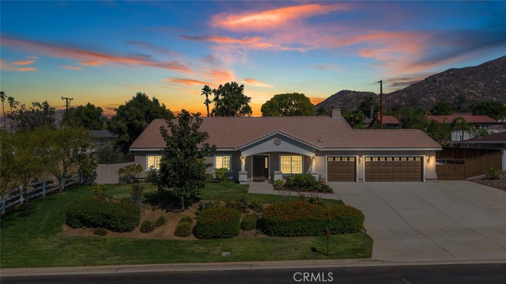 Welcome Home! This single story ranch style home is a rare find! Situated on a 27,442 square foot lot with gated oversized RV/boat parking. This home is stunning and immaculately maintained! Offering approximately 2,662 square feet 4 bedrooms and 3 bathrooms. Ceramic plank tiles (wood looking) throughout all main areas of the home. Oversized primary bedroom and bathroom that features dual sinks, stand alone shower and deep soaking tub, with a large walk in closet. Chefs dream of a kitchen, this expansive kitchen is great for family get togethers or entertaining! HUGE oversized island with bar seating, granite countertops, stainless steel appliances, and walk in pantry. The dining room is just off the kitchen, with all three spaces; Kitchen, dining and family room merging to create a massive open flowing space that works seamlessly together. Additional interior features include, ceiling fans, mirror wardrobes, high ceiling and gorgeous custom plantation shutters throughout and so much more. An individual indoor laundry room with cabinets. The backyard is just AMAZING with a patio cover that expands the full length of the home, and two individual free standing alumawood pergola's with ceiling fans. Artificial low maintenance grass, garden, fruit trees, (orange, lime, lemon, avocado, all fruit bearing trees and a private gated dog run! For those with an adventurous spirit, the property includes dedicated RV parking, ensuring your travel-ready vehicle has a secure spot. Still more room to. add a boat or more toys and or work vehicles. The exterior of the home has just been repainted! Low taxes and no HOA. This home is a rare find, move in ready and so well cared for it feels new! Don’t Miss Out! This home will sell fast.