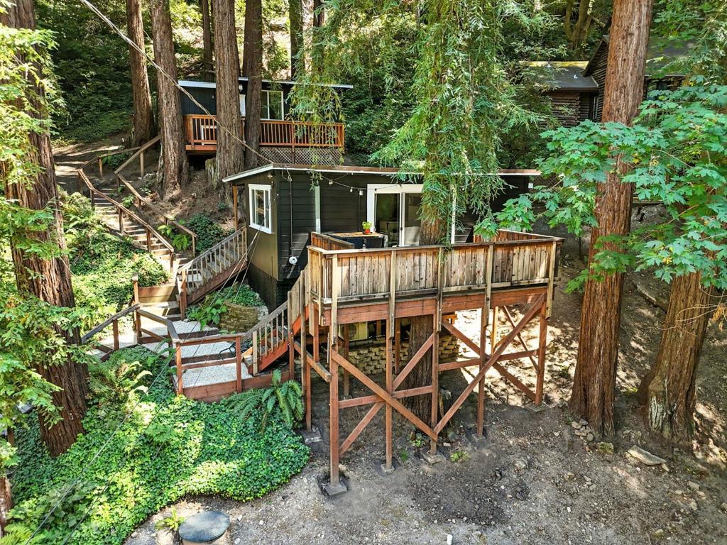 Tucked into the redwoods yet surprisingly close to San Jose, this well-maintained home is your gateway to a life of outdoor adventure and unexpected charm. Whether you're a road cyclist chasing epic climbs right from your doorstep or a mountain biker looking to hit world class trails just 3 miles away, this location delivers. Prefer to keep your feet on the ground? You're surrounded by endless hiking trails and only 15 to 20 minutes from the beach. But this isn't just about nature, it's about lifestyle. Cruise up E. Zayante Road to dodge Highway 17 traffic, grab a bite at the beloved Zayante Market, and on a Friday night? Walk to a secret indie band show. Yes, really. (But shhh)! There's even a free food church every Friday (its awesome), and a tight knit neighborhood where everyone knows your name. You'll love the updated HVAC (heating, cooling, and dehumidifying) and modern septic system because living in the woods doesn't mean roughing it. The Trout Farm is just down the road, your neighbors are your friends, and your weekends can be whatever you want: beach, bike, band, or all three. Welcome to your new kind of California living. Please note, 617sqft is the total COMBINED sqft between the main home and separate studio.