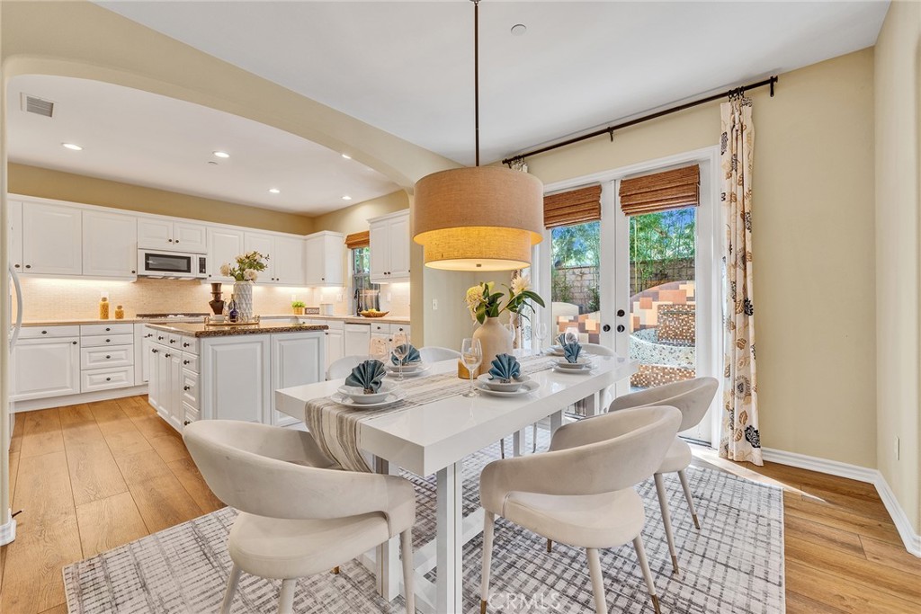 EXQUISITELY FORMER MODEL HOME, PREMIUM CORNER LOT LOCATION, fully loaded with high-end builder upgrades. WALKING DISTANCE TO WOODBURY TOWN CENTER - One of Irvine’s most vibrant retail hubs. JUST STEPS AWAY FROM THE COMMUNITY IRIS GARDEN PARK & THE PALM CLUB. MAIN FLOOR BEDROOM WITH FULL BATH — perfect as a guest suite or an office, complete with gorgeous custom built-in shelves and upgraded glass-door cabinets. Extensive designer features include newer wood flooring, upgraded carpet, surround sound throughout the home, custom bamboo window coverings and plantation shutters, elegant Chandelier, textured wallpaper, crown molding, wainscoting and a large full size upstairs laundry room offers many built-in cabinets, utility sink, and window! Gourmet kitchen is equipped with designer granite countertops, stone full backsplash and a large pantry with a center island and opens up to the dining and family room. Grand master bedroom offers large walk-in closet, separate custom bathtub and shower with abundant use of beautiful travertine-style stone finishes – adding a touch of luxury and lasting style. Upstairs the LOFT area has custom cabinets for extra storage and linens. Enjoy the gorgeous private backyard with custom pavers and mature trees very easy to maintain. 2 car garage with TESLA WALL CHARGER and direct access to home. The Community Palm Club offers a Junior Olympic pool, wading pool, spa, fitness center with cardiovascular and strength-training equipment, a 2,470 sqft recreation building with multi-purpose room and kitchen, full-court basketball and tennis courts, a tot lot, picnic tables, a barbecue area, and a great lawn area. Just a short walk to Woodbury Town Center – filled with major realtors like Trader Joe’s, The Home Depot, HomeGoods, LA Fitness, Starbucks, Ralphs, Walgreens, banks and restaurants! Minutes from Top-Rated Irvine Schools, John Wayne Airport, Irvine Spectrum, beaches and more!