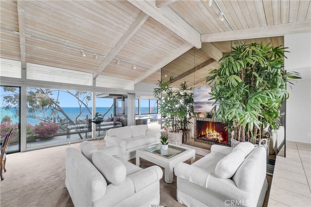 A Rare Gem in North Laguna with Unmatched Ocean Views!
Opportunities like this are few and far between. A stunning home situated on a flat, quiet cul-de-sac in coveted North Laguna, offering unobstructed 180-degree ocean, coastline, and city views. This exceptional property blends casual coastal elegance with the relaxed charm of beachside living.
Enter through a beautifully landscaped courtyard featuring a rustic fountain designed by local artist Dan Skaggs, lush tropical foliage, and a serene ambiance that sets the tone for what lies beyond. Inside, you're immediately greeted by panoramic views of the Pacific and endless blue skies. The kitchen features a glass sunroom dining area with a surround view that invites you to start your day with breathtaking scenery.
Spanning two levels, the home boasts expansive balconies on both floors, perfect for entertaining or unwinding with a glass of wine at sunset. The main level offers a spacious private suite with it’s own sitting area and a full bathroom, a second bedroom and full bathroom, alongside a gorgeous living room that flows into a cozy conversation space with a double-sided fireplace and wet bar, all overlooking the ocean.
Downstairs, the primary suite is a private retreat, complete with a large ocean-view deck, a jacuzzi on the deck, a generous walk-in closet, and a spacious en-suite bath. A fourth bedroom and a full bathroom has been added and beautifully renovated, both permitted, with its own separate entrance, which allows for it to be used as a separate guest room.
Additional highlights include a solar energy system, ample street parking, 2 car garage, new roof, new furnace, and more. This is a beautiful and move-in ready home with the flexibility to personalize or transform into your dream luxury estate.
Located just minutes from Heisler Park, amazing hiking trail, world-renowned beaches, top-rated schools, fine dining, art galleries, and The Ranch golf course, this property exemplifies the best of exclusive Laguna Beach living.