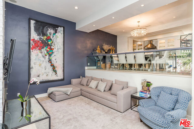 Stunning remodeled rare Beverly Hills townhome in the heart of Beverly Hills! This spacious designer townhome boasts over 2,100 SF with 3 Bedrooms, 3 Bathrooms, hardwood floors throughout and a large private patio, perfect for entertaining guests. Enter the open concept split-level living/dining area with soaring high ceilings, fireplace, and access to the large private patio. Beautifully crafted kitchen with high-end stainless steel Viking appliances, quartzstone countertops, range kitchen/oven, deep Farmhouse-style sink, and custom built-in cabinetry. Upstairs, a master suite with a beautifully updated master bathroom featuring marble rain shower, dual sinks, and a large walk-in closet. 1 additional bedroom upstairs and 1 downstairs plus a separate laundry room. Unit is in desirable quiet rear location with direct entry from the private garage. Ideally located in prime Beverly Hills and boasts Beverly Hills School District (buyer to verify). AGENT PLEASE SEE PRIVATE REMARKS.