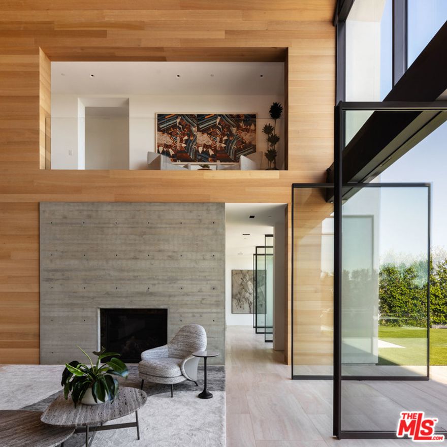 AIA Los Angeles award winning property meticulously designed by Standard Architecture, 1471 Forest Knoll is an irreplicable modern farmhouse in the iconic Hollywood Hills. A masterwork home by Viewpoint Collection, the property sits on an approx. 1 acre promontory enveloped by soaring palm trees and explosive views. The estate welcomes you with 3 parallel gabled volumes centered by an astonishing 30 ft great room. The pitch of its ceiling guides the eye toward the rear wall where exquisite glazing reveals breathtaking, unobstructed vistas from Downtown to the Ocean. Amenities abound, the home provides endless luxuries include Styline doors for indoor/outdoor living, home theater, sumptuous master w/dual closets, remote control shades, well-appointed guest suites, gym w/outdoor lounge & shower, home theater, Crestron system, Sonos Sound, ample driveway parking & dual garages. It's all brought together by timeless travertine paving & simple landscaping that culminates in a 20x73 ft infin