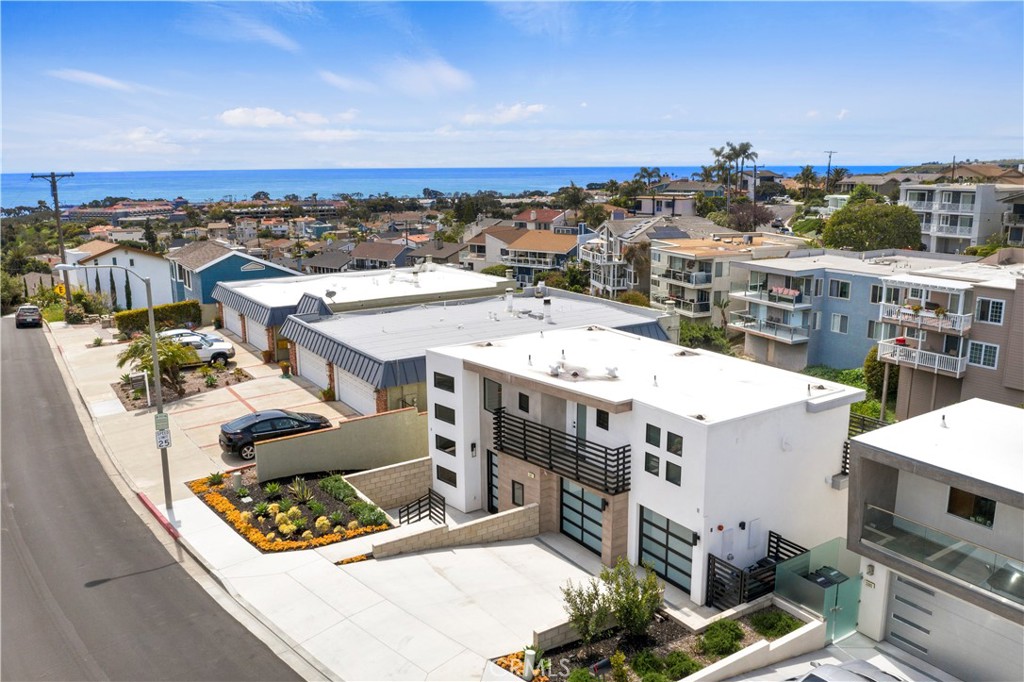 One-of-a-kind designer home available in the heart of Dana Point. This home was newly built in 2017, featuring designer elements and high-quality finishes. This 4-bedroom, 4.5-bath home spans three levels of modern, sleek architecture. Anchored by a statement-piece floating staircase that connects all three levels, 33871 Calle La Primavera is an entertainer's dream and sure to be a topic of conversation. Three decks seamlessly bring the outdoors in, offering canyon and city views of the charming Dana Point Lantern District. The gourmet chef's kitchen boasts Calcutta quartz counters and backsplash, stainless Samsung appliances, sleek cabinetry, modern hardware, a wine fridge, and a built-in coffee bar. Additional upgraded features include white oak hardwood floors throughout, a modern accordion door leading to the outdoor deck, two contemporary fireplaces illuminated with LED lights, designer light fixtures, and a spacious master retreat with a spa-like bathroom. An added bonus room can serve as an office, theater, or exercise room. This home is available fully furnished, although this is negotiable. It is within walking distance to the Lantern District, Doheny Beach, and Dana Point Harbor.