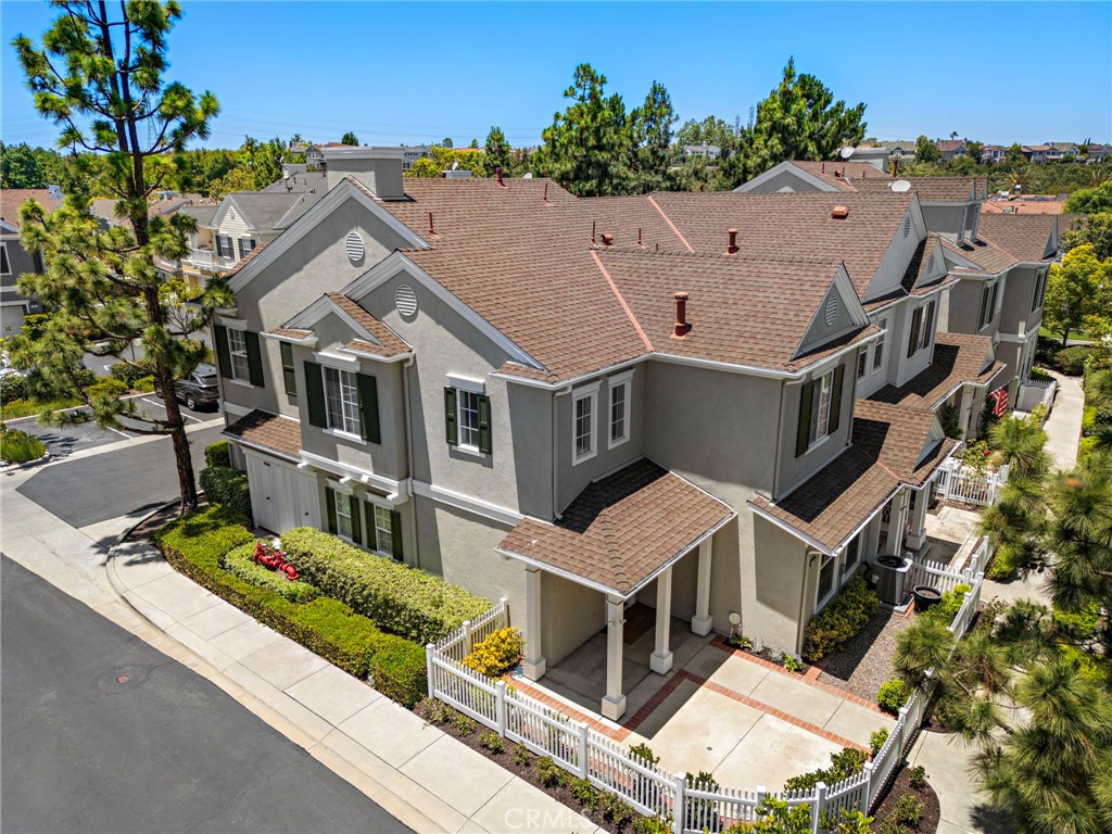 Freshly updated and offering a premium elevated End Lot Location in the Charleston Place enclave of Ladera Ranch’s Avendale Village, this impressively upgraded, light and bright, townhome is move-in ready. Proudly displaying Colonial-inspired architecture, this home boasts possibly the “best in tract location” facing Gilly Flower St on an elevated, corner, end lot with only one attached neighbor and a gated oversized front patio with a classic white picket fence. There is ample room for outdoor entertaining, stargazing, relaxation or simply hanging out with neighbors as they stroll down the tree-lined street. Natural light illuminates the open-concept interior, where a double-height entry reveals a multi-tiered staircase and leads to a seamless living and dining room with custom fireplace. Open to the dining room, the remodeled kitchen showcases white cabinetry, quartz counters, a full subway-tile backsplash, built-in pantry, and stainless-steel appliances. Upgraded Natural Timber Whitewash tile plank flooring lends warmth throughout the first level, which also features a powder room and attached two-car garage. Approximately 1,753 square feet, the three-bedroom, two- and one-half-bath design continues upstairs with two light-filled and spacious secondary bedrooms and a convenient laundry room with cabinetry. The fully appointed primary suite is distinguished by a sunny window seat and an abundance of natural light, walk-in closet, and a private bath with barn door, soaking tub, separate shower, two sinks and quartz counters. Enjoy NEWER AC, Hot Water Heater, and Dishwasher, new interior paint, custom window treatments, designer carpet in bedrooms, custom recessed LED lighting throughout, and upgraded plumbing fixtures, bathroom mirrors, and door and cabinet hardware. The Cherry Plunge Pool, Park & Playground are less than a block from house and it’s just a short walk to: the Avendale Clubhouse with its pool, lap pool, kids pool, splash pad, and pickleball/basketball/tennis courts; Poets Park; the Ladera Ranch Library; Skate Park; newly renovated Water Park; Founders Park with its weekly Sunday Farmers Market and annual July 4th Firework Show; and highly-rated Ladera Ranch Elementary & Ladera Ranch Middle School. Plus miles of scenic hiking and biking trails, private security, and abundant shopping and dining are located within the community while the coastal towns of Laguna Beach, Dana Point and San Juan Capistrano are remarkably close.