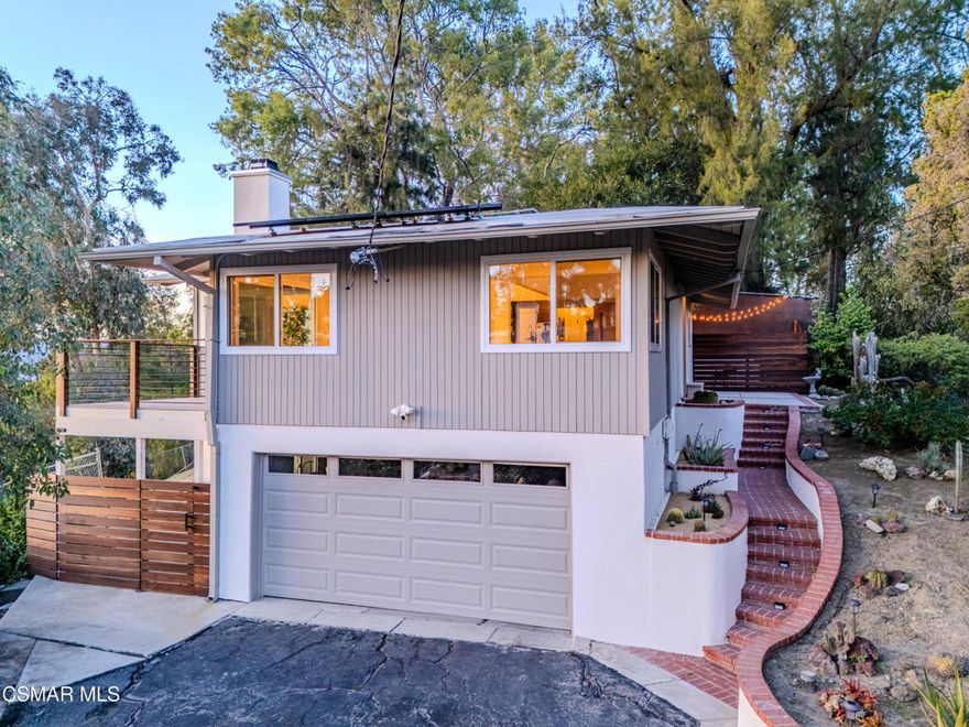 This mid-century modern 2 bedroom, 2 bath home is situated South of the Boulevard in the hills above the buzz of the city.  Beautifully and thoughtfully updated, including new windows throughout that flood the house with natural light and offer gorgeous treetop and mountain views.  This home features an open floor plan, complete with vaulted ceilings and skylights. Enjoy golden hour and pink sunsets from the deck and nearly every room of the house. The primary bedroom has an en suite bath with a herringbone tiled accent wall. The secondary bedroom, with closet and sliding door to the private side yard, is currently being used as an office - a wall would complete this as a bedroom. The long driveway to the attached two car garage offers plenty of coveted off street parking. Mature cacti and succulents line the steps to the front door, while the large 17,000sf lot offers endless opportunity to create the backyard of your choosing.  Mechanical systems have been upgraded and the property features ample rooftop solar panels, a Tesla powerwall battery and battery monitoring system.