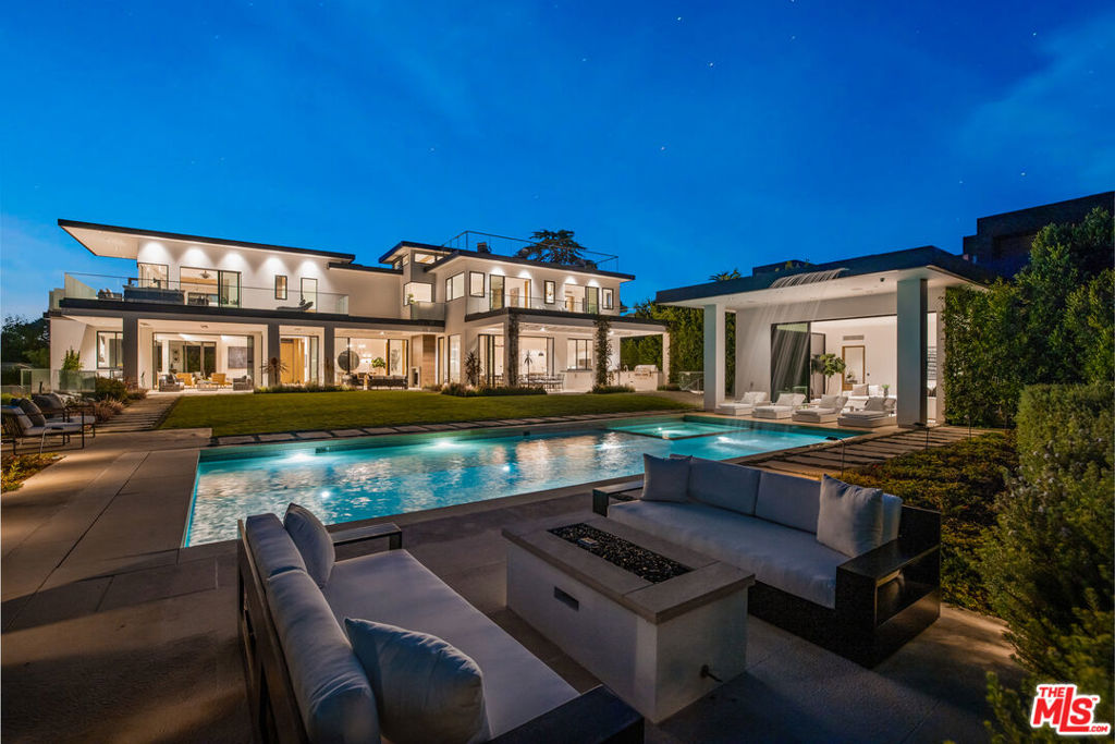 In the heart of prestigious Beverly Hills, this contemporary estate boasts state-of-the-art design and breathtaking city views. Seamlessly integrating indoor and outdoor living, the property features light-filled spaces, natural elements, and high quality finishes. Floor-to-ceiling glass walls reveal captivating views. The main level is perfect for entertaining, offering a stylish living room with a bar, a formal dining room, and a chef's kitchen adjoining the family room. The estate includes plentiful guest suites and features a primary suite that includes dual luxurious bathrooms and closets, a sitting area, amazing views, and a wrap-around terrace. With expansive balconies and decks around the home, including a rooftop lounge, this property is designed for ultimate enjoyment. Other highlights include a great room, home theater, gym, and wine room. Outdoors, the heated loggia, outdoor kitchen, lawn, pool, spa, and cabana complement the mesmerizing vistas. Equipped with Creston home-automation, a six-car auto gallery, and an elevator, this extraordinary estate blends contemporary elegance, organic materials, and cutting-edge technology a perfect choice for the discerning luxury buyer.