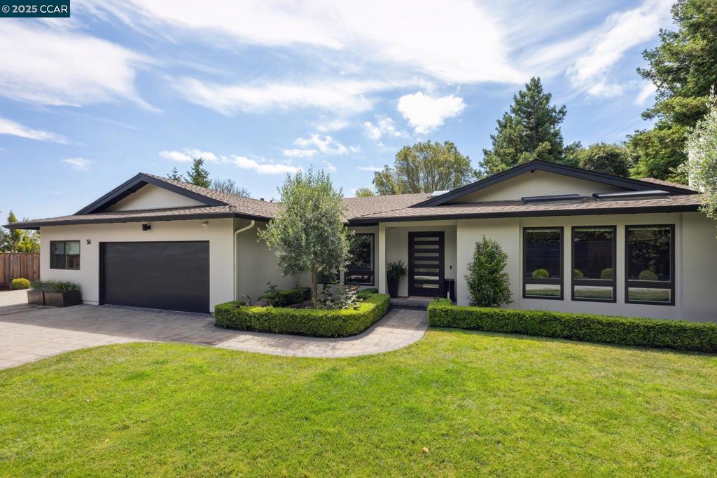 Modern luxury meets timeless design in this stunning, renovated one-level home tucked behind gates & set back from the street. W 4 beds, 3 baths, & details. Gourmet kitchen boasts a Calcutta marble island with custom edge, Bertazzoni range, Perrin & Rowe fixtures, Slave cabinetry, and a walk-in butler’s pantry with marble slab backslash, open shelving and Fisher & Paykel wine fridge. The living room boasts a dramatic floor-to-ceiling stone fireplace and large picture windows and access to the garden spaces. Adjacent, the dining room with Roman clay wall finish offers Calacatta marble beverage center, open shelvings and views of the gardens; perfect spaces for indoor outdoor entertaining. Spa-like primary boast Roman clay walls, spacious a walk-in closet & luxurious bath w Carrera marble w Phylrich fixtures. Moody office features built-ins w open shelving & pocket French doors. Cozy & chic family room w fireplace, built-ins & blackout shades. Private guest suite,2 additional bedrooms & designer baths complete fabulous interior spaces. Gardens boast expansive patios, lawns, veggie beds, olive trees, redwoods, and breathtaking Mt. Diablo views. This private oasis is just minutes to downtown, top schools & BART—20 min to SF!