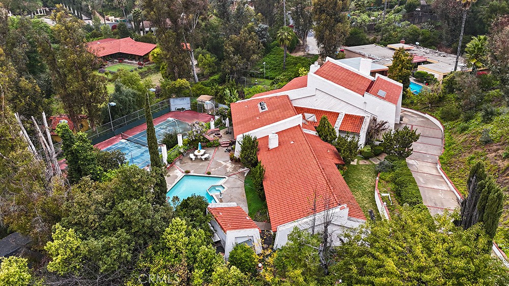 Nestled in the prestigious Cowan Heights neighborhood, this spacious two-story estate offers a rare opportunity to create your dream home in one of the area's most desirable locations. The residence features expansive rooms with high ceilings, abundant natural light, and flexible layouts ready for your vision and updates. The property includes four bedrooms, multiple bathrooms, and large living and dining areas, providing ample space for family or entertaining. Outdoors, enjoy the sparkling pool, private tennis court, sauna, and generous gardens with serene hill views, all ready to be revitalized. Conveniently located near top-rated schools, shopping, dining, and major highways, this home offers both space and an unbeatable Cowan Heights location. This property is perfect for buyers seeking a classic estate with tremendous potential.