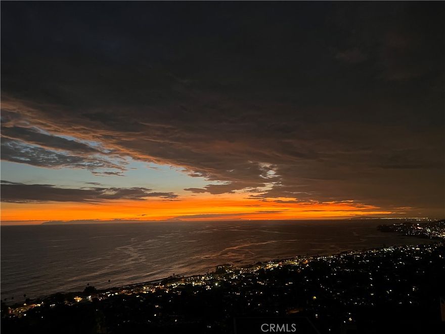 Dramatic Ocean View Architectural Masterpiece in Laguna Beach



Perched in one of Laguna Beach’s most breathtaking settings, this four-bedroom, three-and-a-half-bath architecturally rich residence offers endless Pacific Ocean views, from the shimmering waters by day to the dazzling coastal lights by night. Designed to maximize the panoramic scenery, retractable glass doors seamlessly merge indoor and outdoor living, inviting in the ocean breeze and framing the stunning vistas.



Spanning 4,951 square feet on a 6,500 square foot lot, this custom contemporary masterpiece is a sanctuary of style and sophistication. The open living spaces flow effortlessly to a spacious ocean-view terrace and a rare Laguna Hillside Garden, where outdoor seating, lush lawns, mature olive trees, and a vibrant flower garden create a serene retreat.



The chef-inspired kitchen is designed for function and beauty, offering top-tier appliances and stunning ocean views. A separate dining area provides a picturesque setting with views of the coastline and garden. The living space is designed for grand entertaining, enhanced by soaring ceilings, architectural art lighting, and generous gallery-like wall space.



A sculptural interior staircase and 100-year-old patinated maple flooring add to the home’s distinctive character. The temperature-controlled wine room, capable of storing up to 700 bottles, provides ample space for wine enthusiasts. The luxurious master suite features a private ocean-view balcony, spa-like bath, and his-and-her dressing areas. Two additional en suite guest rooms, both with ocean views, provide comfort and privacy. A convertible media room offers flexibility for additional living space.



Additional highlights include:



Elevator access to all levels

Oversized garage with a private gym

Whole-house audio and high-end finishes throughout

Multiple ocean-view decks, including a private master suite terrace with sweeping white-water, coastline, Catalina Island, and city-light views, this exceptional residence is a true coastal retreat, offering the best of Laguna Beach living.