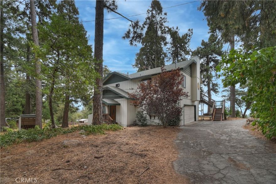 This comfortable mountain home has many desirable features not often found. It is sitting on a large near level lot that has a sunny area for a garden and a shady area near the house; and has dual access off of Skyland or Inspiration. If you enter off the deck you walk into an open concept living-dining area. It has high ceilings and a brick fireplace. In front of the fireplace is a large custom sun made out of slate. It is very attractive next to the distressed wood floor. The kitchen has oak cabinets and ceramic tile counter tops with newer stainless appliances including a 5 burner gas stove. On the upper level is a large bedroom, just painted and an enclosed deck surrounded by windows. This could be a great studio, exercise room or a place to relax. It takes in the unobstructed valley view. Also on the main level is a full bath. Downstairs are two bedrooms and another full bath. The home is equipped with a central vac system and the owner has installed a new dishwasher, refrigerator, furnace and tankless water heater. The oversized two car attached garage has a 220 outlet and a wall of cabinets for the do it yourselfer or a contractor. The property is in a convenient area to get ether down to the city or Highway 18. It has tons of parking for an RV or boat. Possible area for a future ADU. This home is clean and ready to move in.