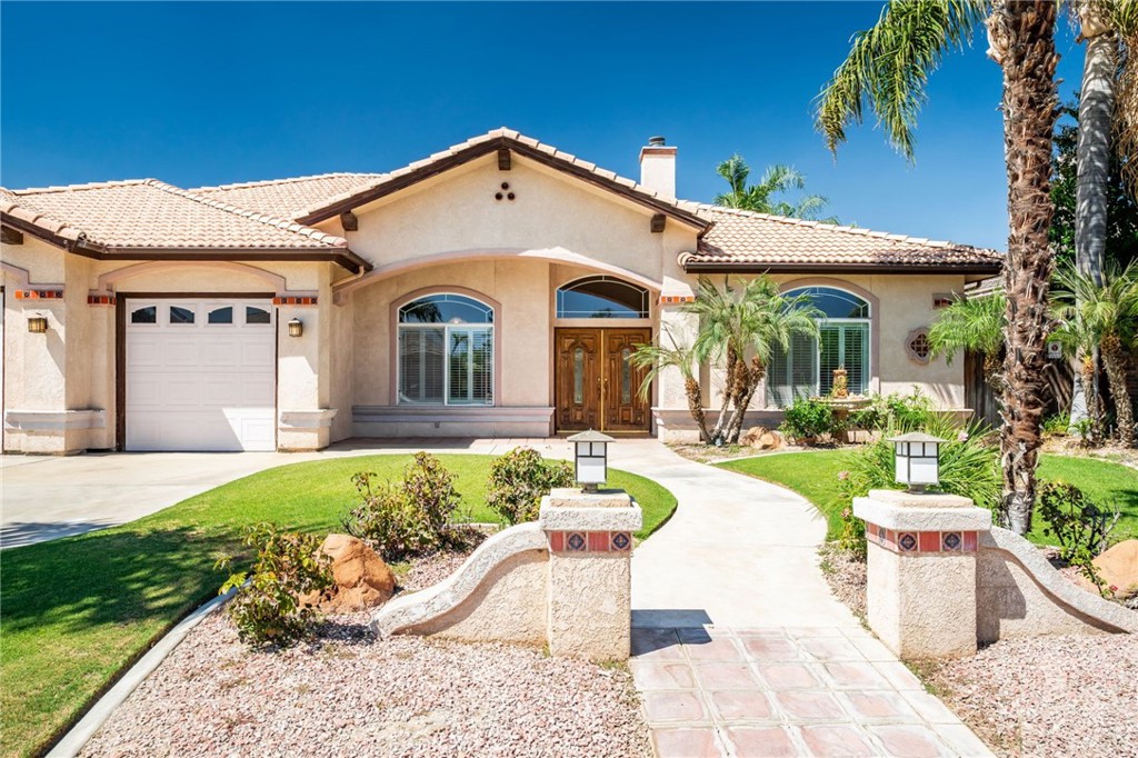 This expansive and beautiful single-story home offers over 2,758 sq. ft. of living space, and a big size lot of 10,890 sq ,ft. featuring 4 bedrooms, 3 bathrooms, and a bright open layout perfect for both everyday living and entertaining. Inside, you’ll find vaulted ceilings, arched passageways, a welcoming brick fireplace, and a spacious family room with custom built-ins. The kitchen is designed with functionality in mind—featuring tile countertops, a center island, and abundant cabinet space—while overlooking the main living areas for seamless interaction.
The primary suite offers a peaceful retreat with a large sitting area, oversized walk-in closet, and a spa-inspired ensuite bathroom with dual vanities, soaking tub, and separate shower. Secondary bedrooms are generously sized with plenty of natural light.
Step outside to your private backyard oasis—complete with a sparkling pool, tropical landscaping, and ample patio space ideal for gatherings. With a charming front elevation, established palm trees, and a spacious driveway leading to a two-car garage, this property combines curb appeal with practicality. A true entertainer’s delight and a perfect place to call home. Your DREAM HOME IS HERE !