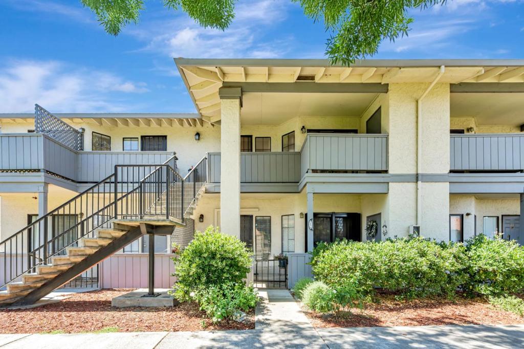Affordable and desirable upper-level 2-bedroom condo located in one of the best spots in the complex, overlooking a peaceful green fieldperfect for outdoor play. This well-maintained home features a spacious living room with vaulted ceilings and recessed lighting throughout, creating a bright and airy atmosphere. The dining area flows seamlessly into the kitchen, which boasts newer quartz countertops, a convenient quick-meal bar, and elegant downlighting. Two light-filled bedrooms provide a comfortable fit for a small family. Enjoy relaxing on the spacious front patio with serene greenbelt views. A detached 2-car tandem garage offers ample storage space. Community amenities include a pool, playground, and guest parking. Conveniently located near shopping and dining options, this condo is a perfect and affordable choice for a starter home.